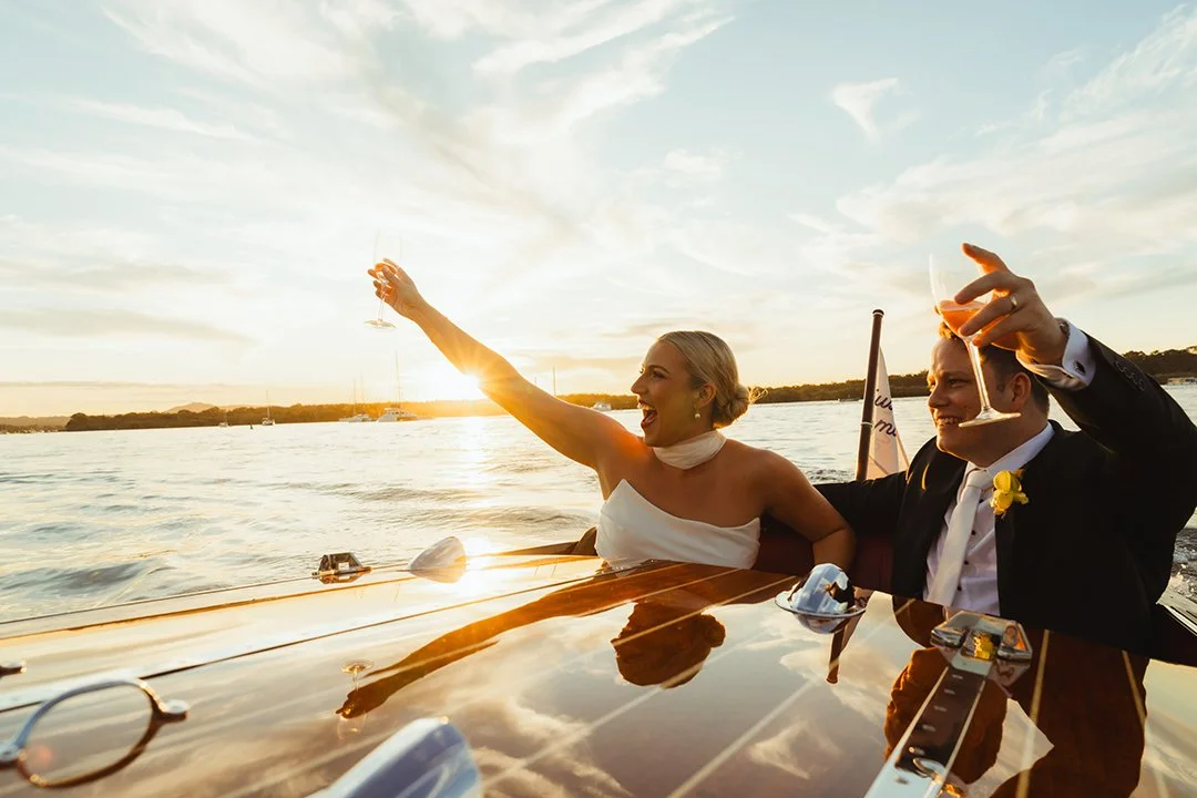 bride and groom at sunset sailing the Noosa river