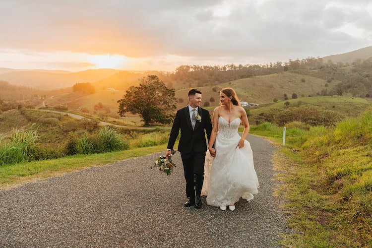 Newly wedded couple walking down road in the Maleny Hinterland