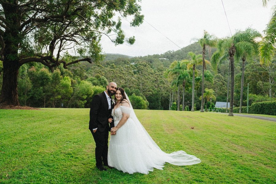 Newly married couple posing for a portrait photo outside Austinvilla Estate
