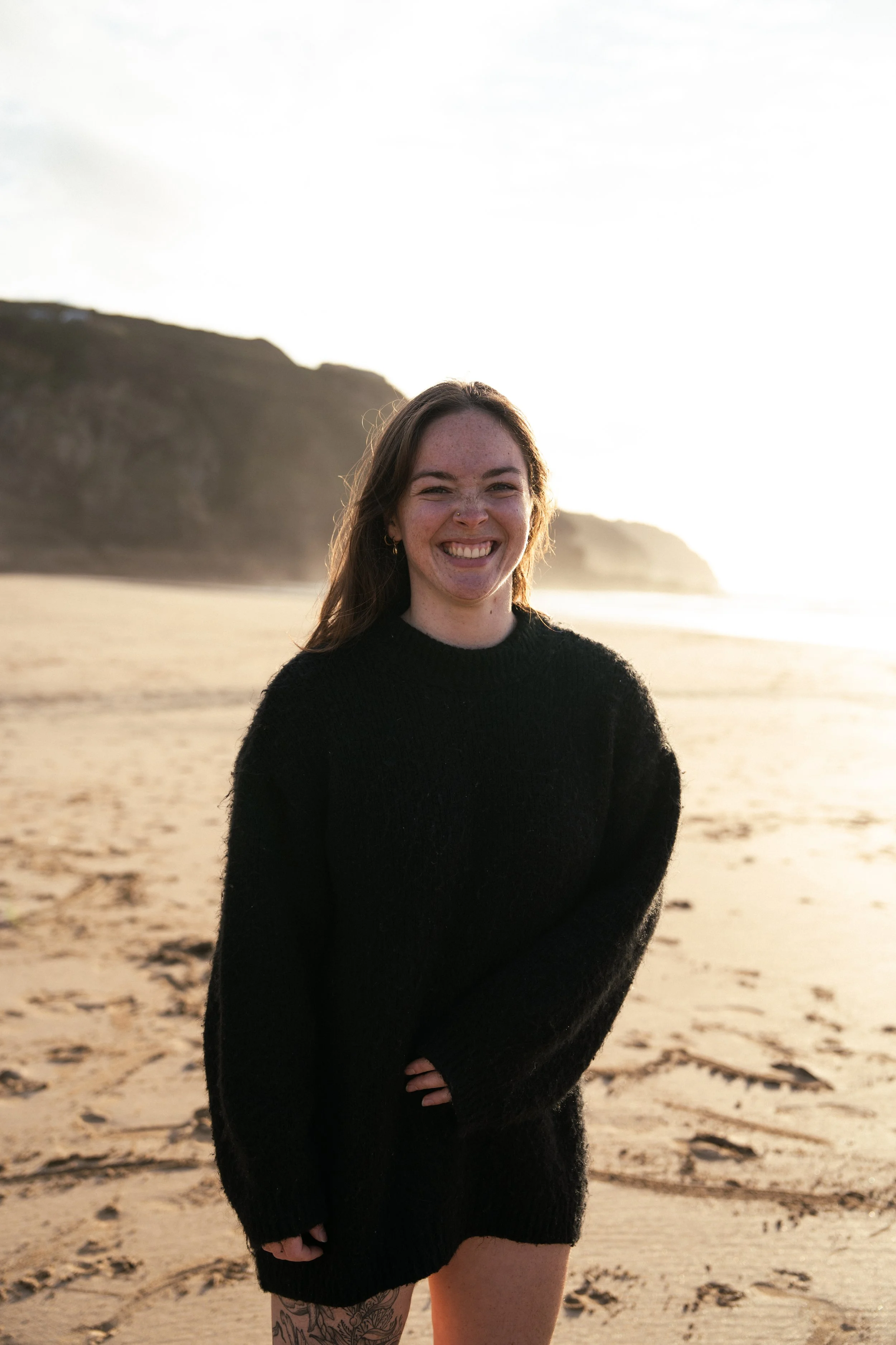 Tash aka vibransea grinning at camera on Cornwall beach
