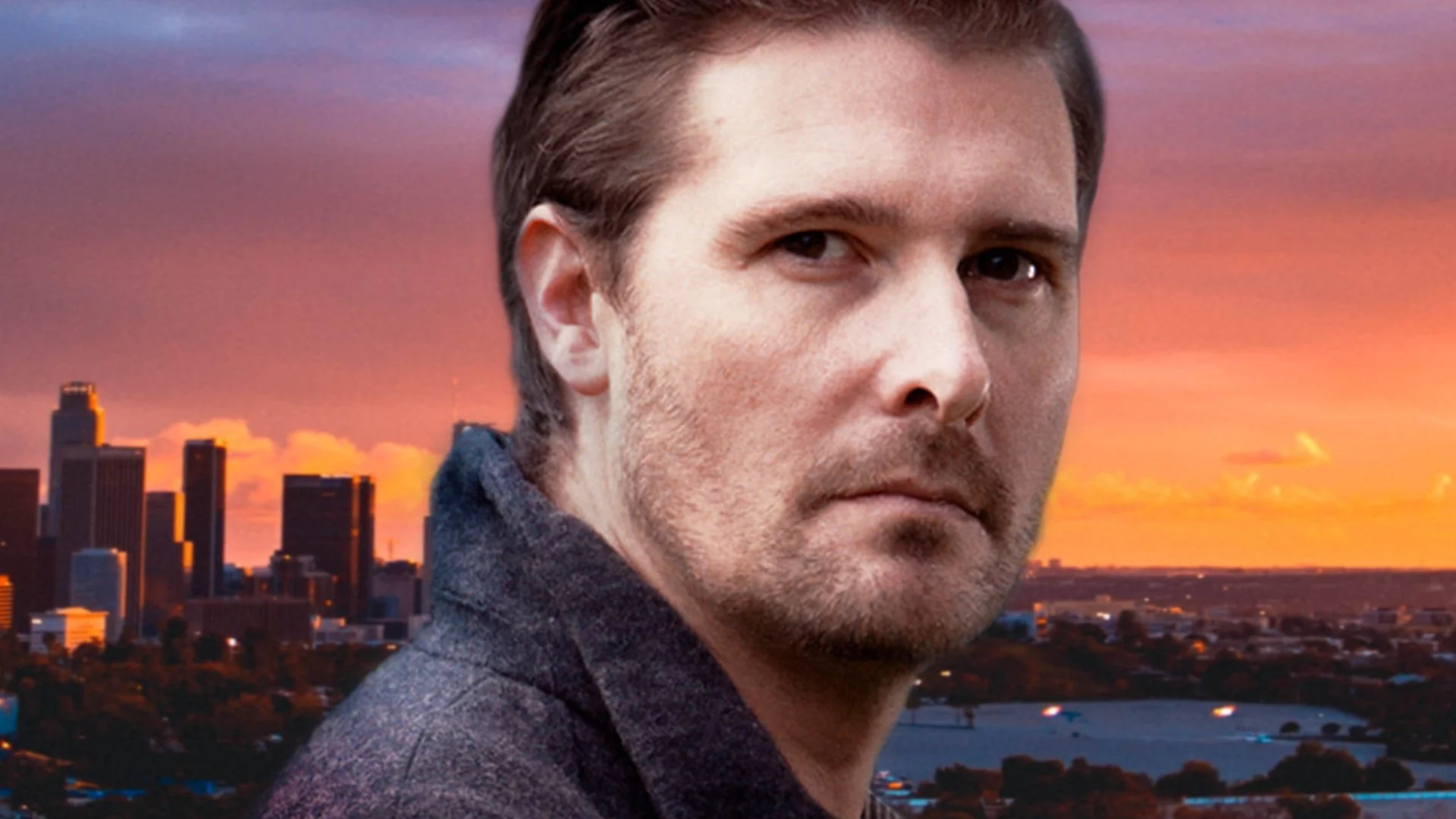 Close-up of a man's face with a city skyline and sunset in the background.