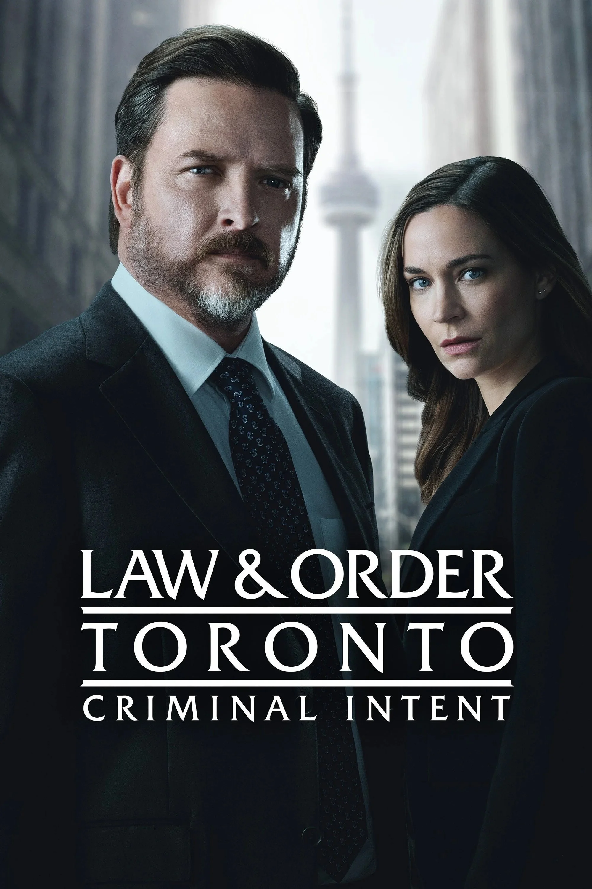 Poster for the TV show 'Law & Order: Toronto - Criminal Intent' featuring a man with a beard and mustache in a suit and a woman with long brown hair also in a suit, with Toronto's CN Tower in the background.