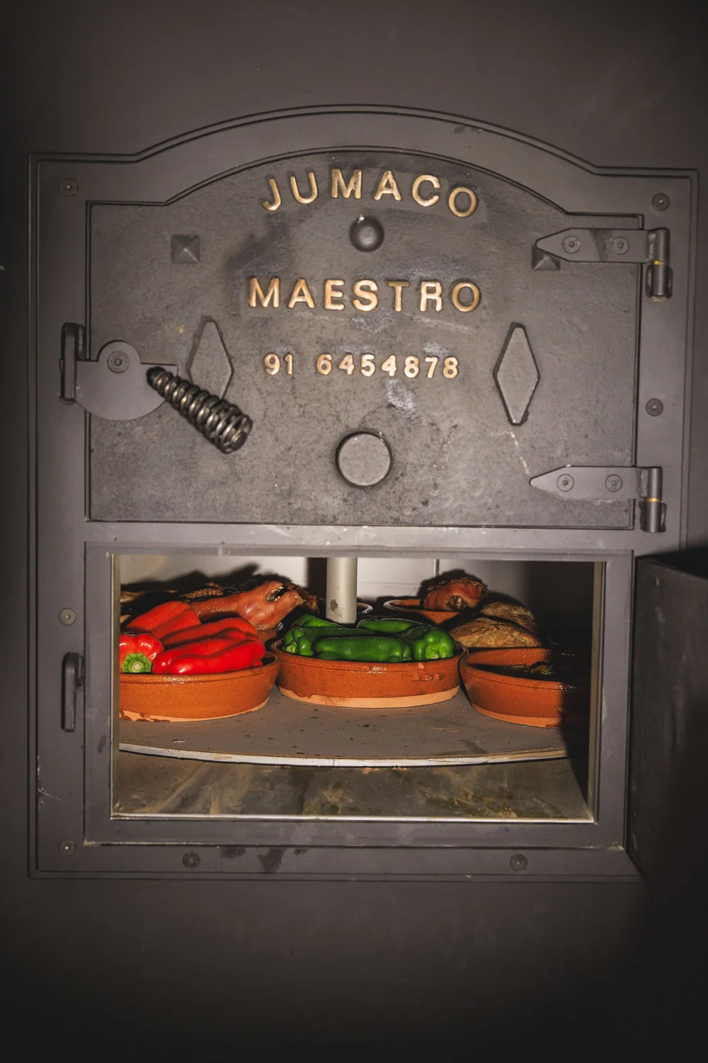 Maestro Jumaco wood-fired oven with roasted peppers at Azahar Spanish restaurant, Sofia