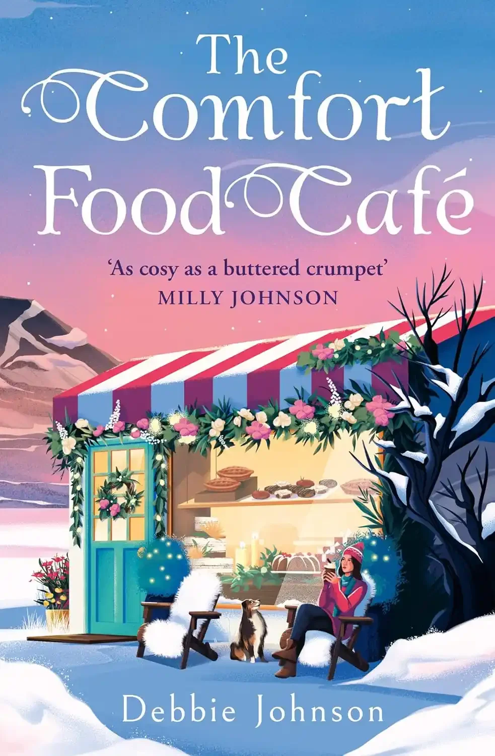 The cover of the book titled 'The Comfort Food Cafe' by Debbie Johnson, featuring a snowy scene with a woman sitting on a chair outside a colorful cafe, holding a cup, with a dog nearby and mountains in the background.