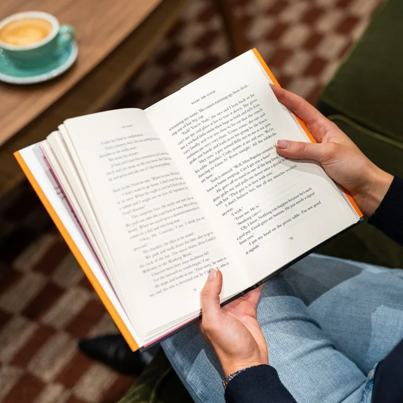 An open book, representing reading, writing, and publishing