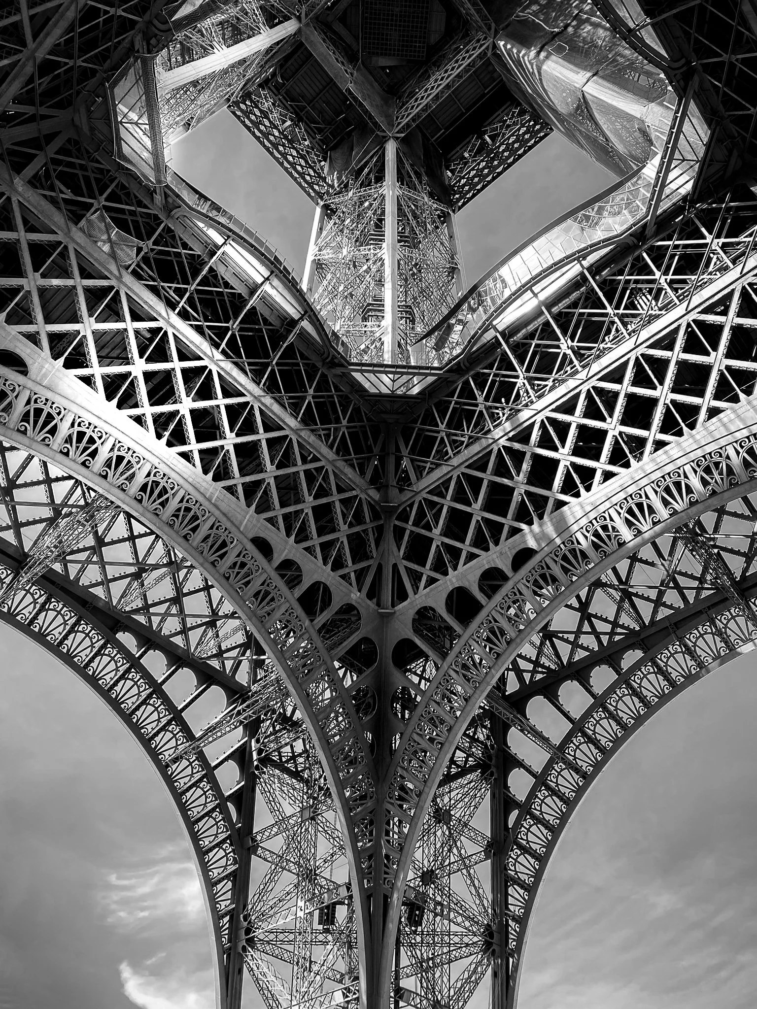 Looking up at the Eiffel Tower, showcasing its iron lattice structure and intricate details.