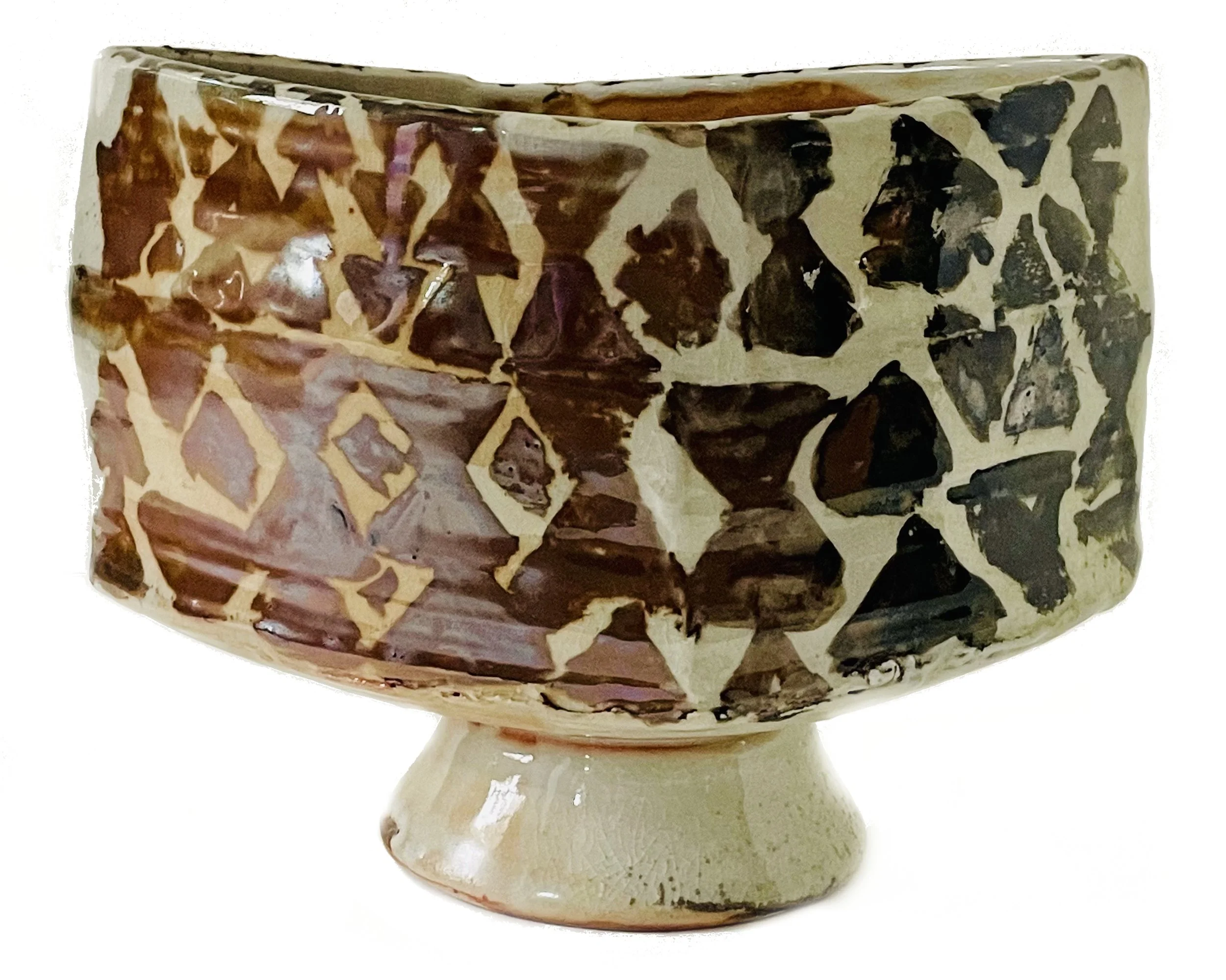 Ceramic bowl with a mosaic pattern of dark and light brown and beige shapes.