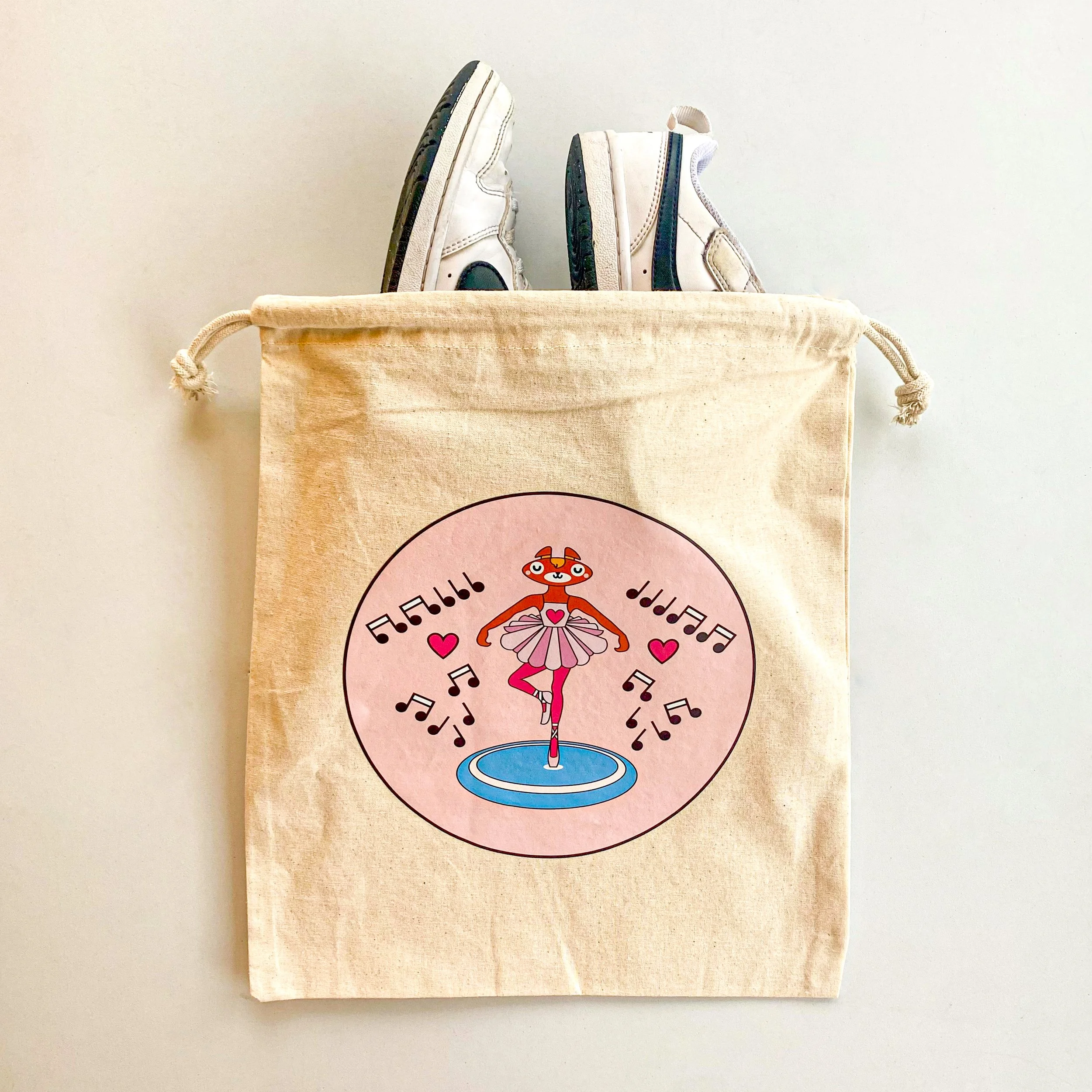 Photo of printed ballerina bag with a pair of shoes stacked into it.