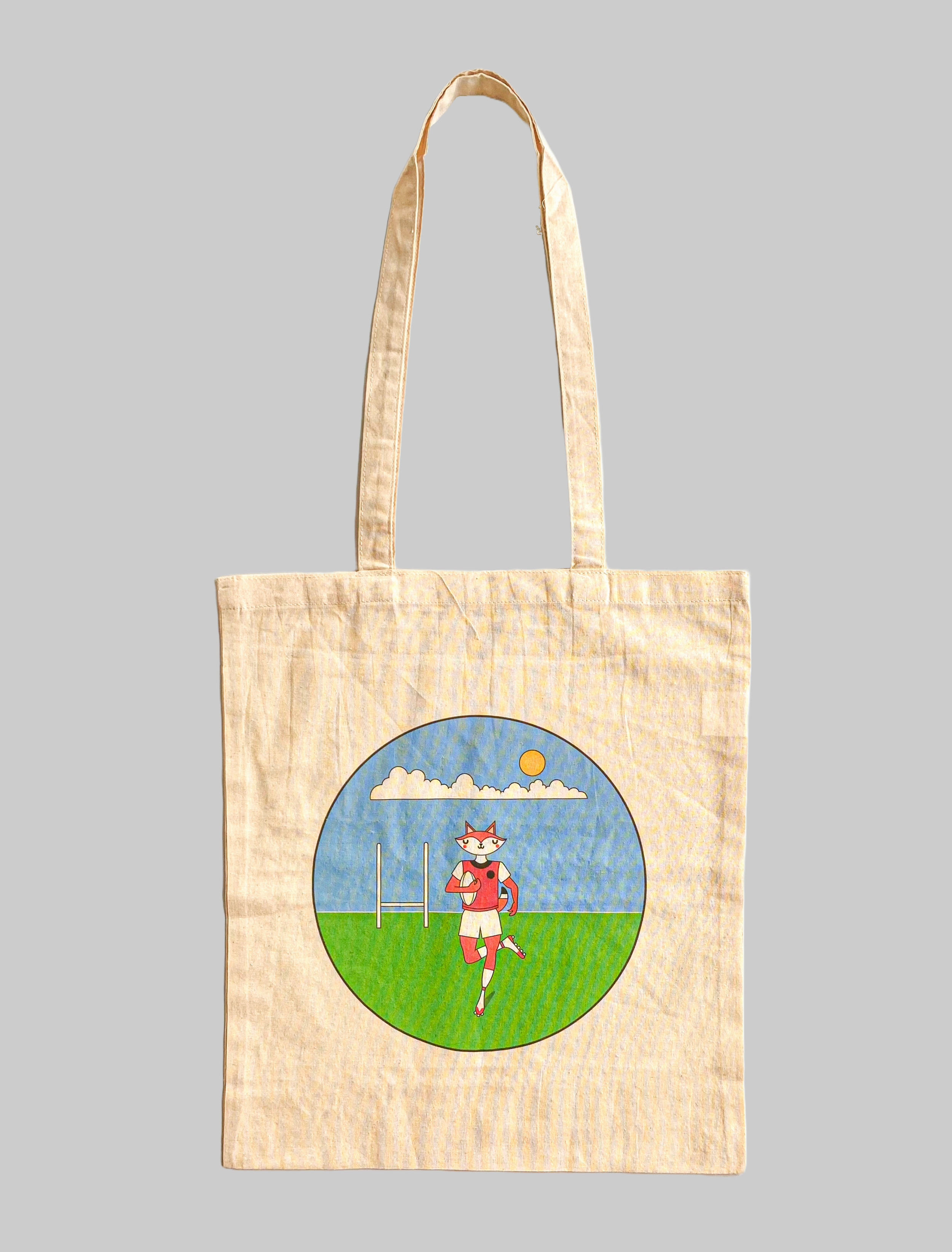 Digital image of a fox playing a game of rugby. Printed logo tote bag.