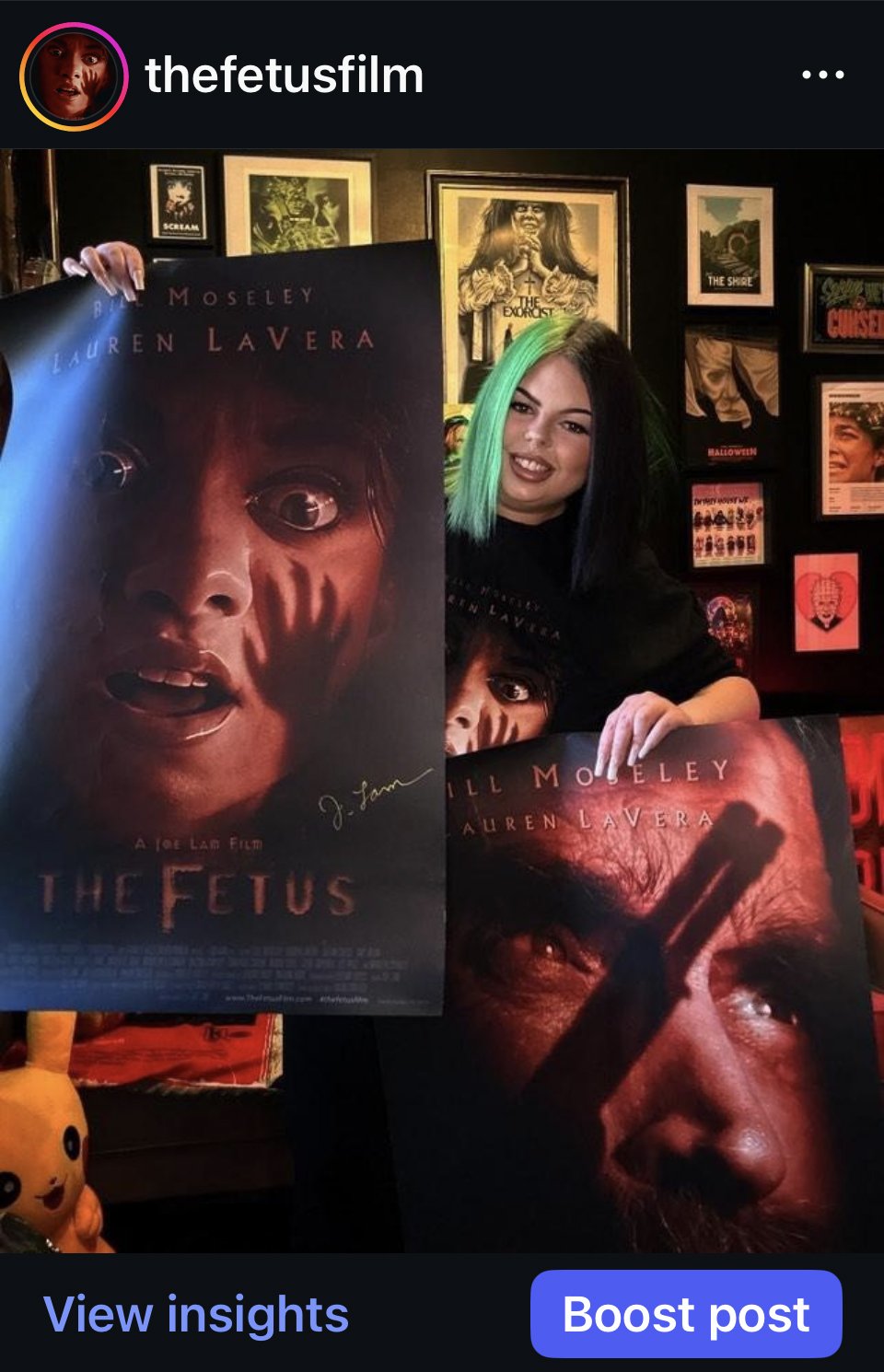 Horror influencer @scaryzaramary holding collector posters from the indie horror film The Fetus during a promotional collaboration.