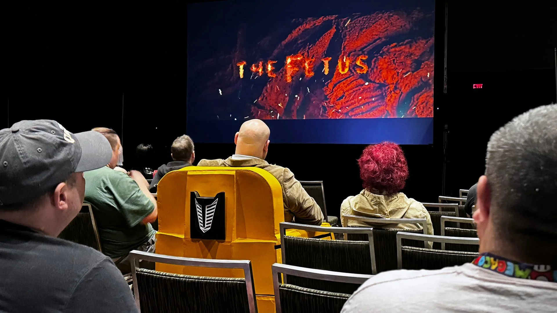 Audience watching The Fetus during a test screening at a horror film event