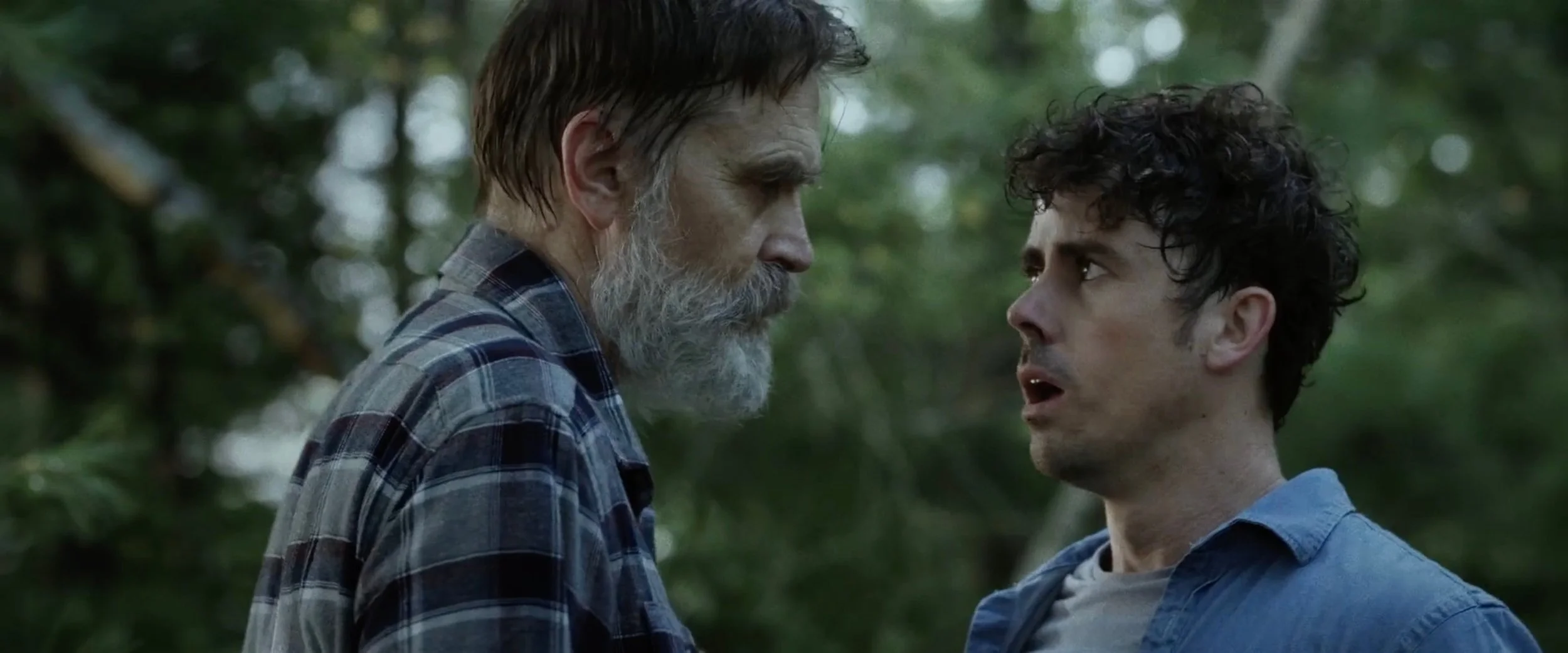 Bill Moseley and Julian Curtis face off in a tense forest confrontation in The Fetus.