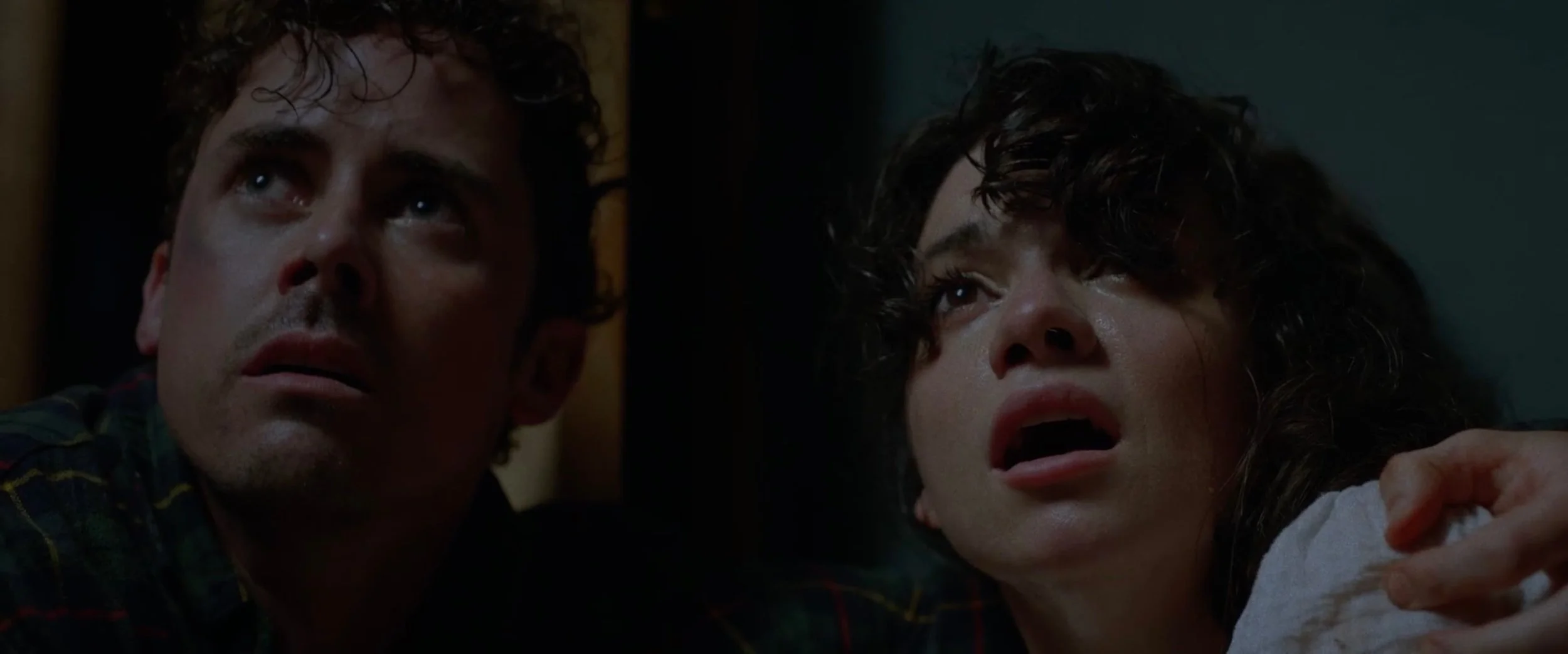 Julian Curtis and Lauren LaVera look upward in fear during an intense scene from the horror-comedy film The Fetus.