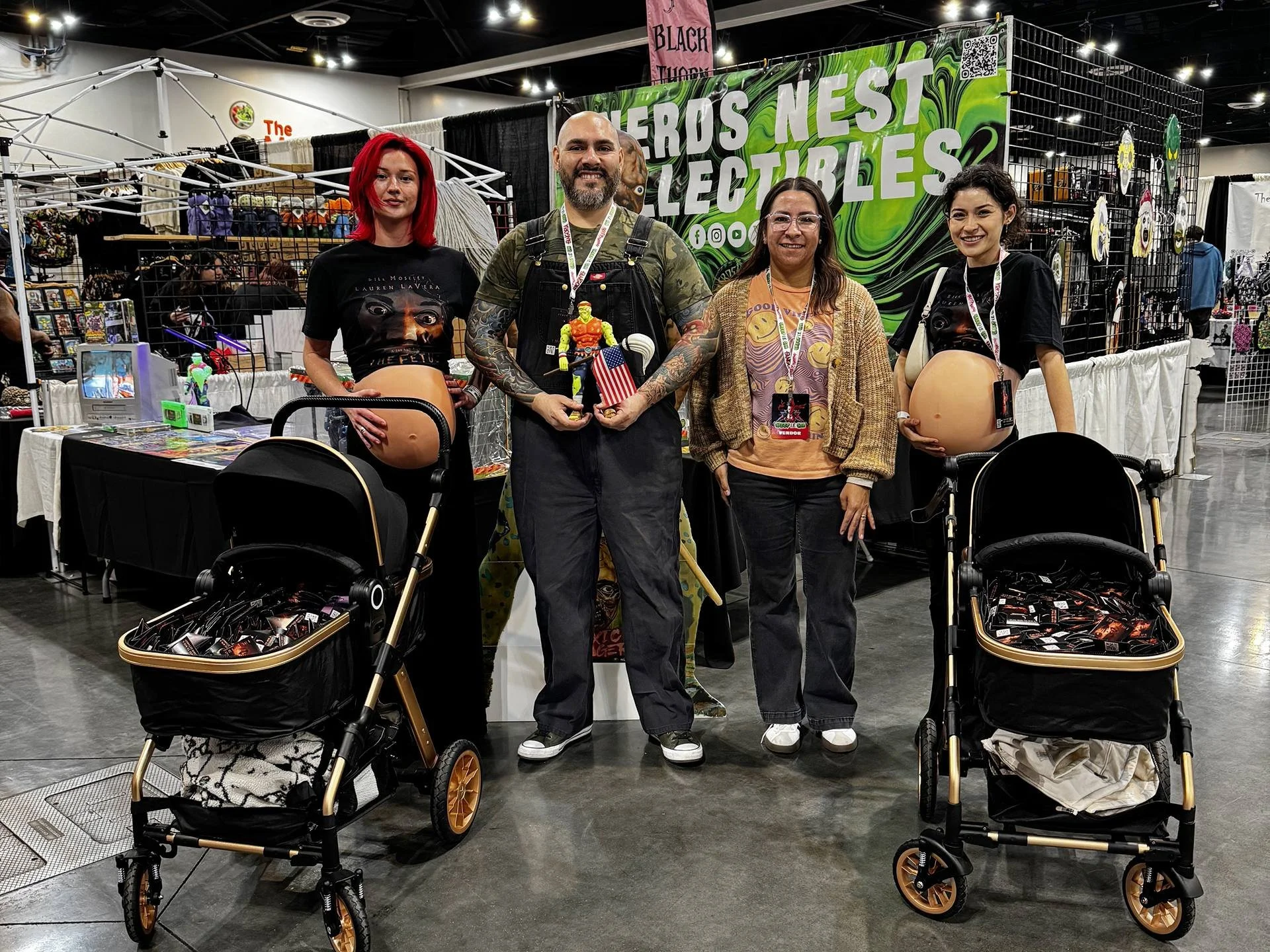 Street team promoting The Fetus film at a horror convention using fake pregnant bellies and baby strollers filled with themed merchandise.