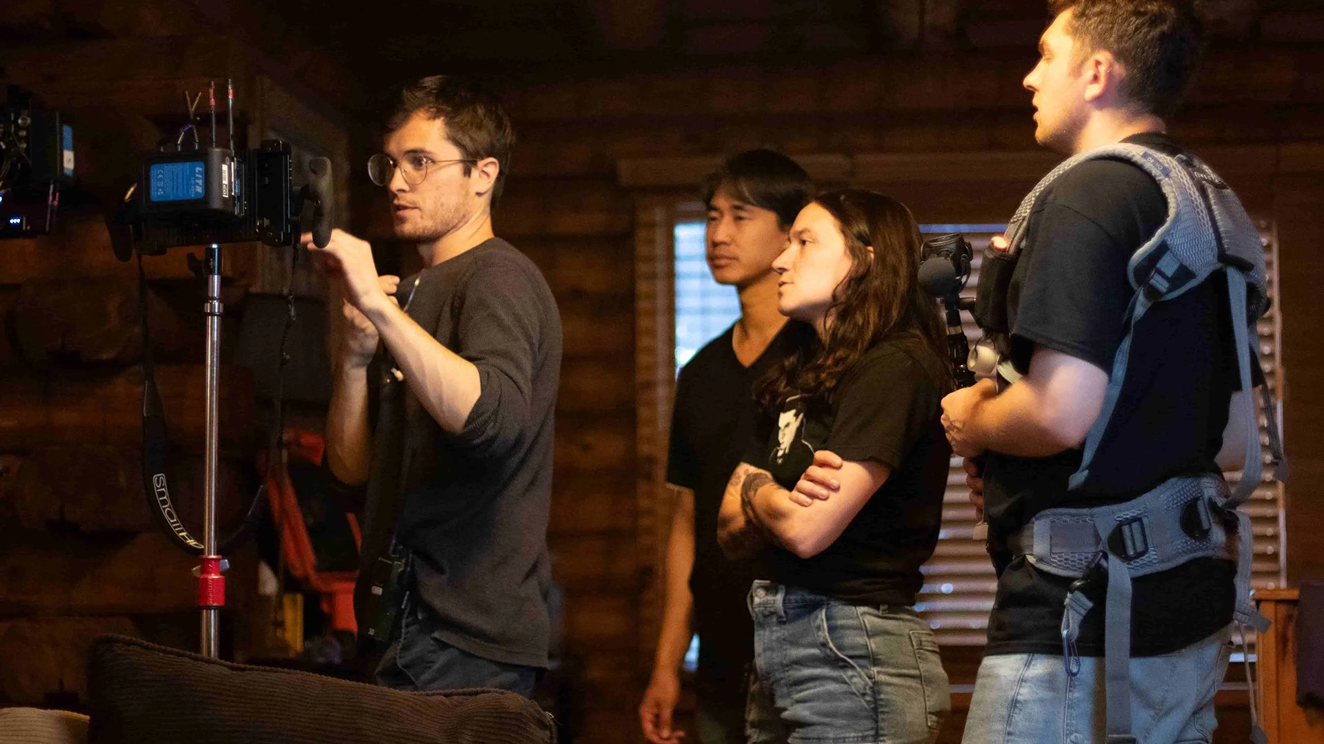 Crew members review a camera monitor on the cabin set of The Fetus during a behind-the-scenes moment in production.