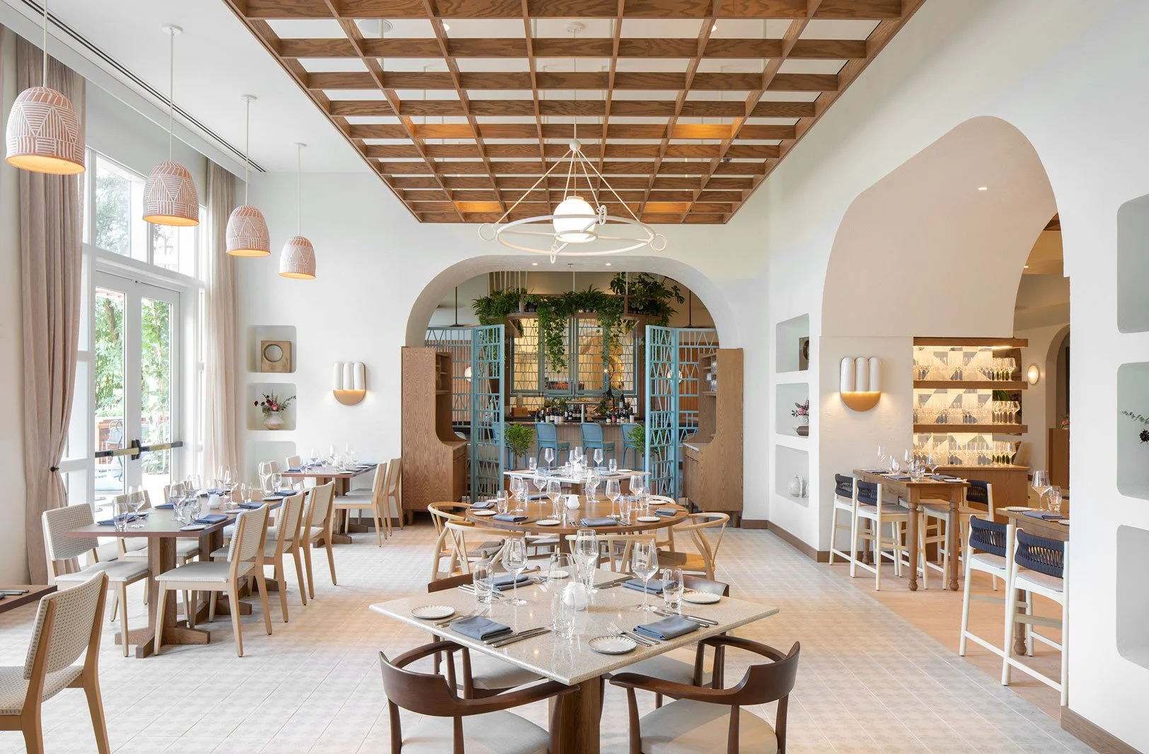 Close-up of a pencil pointing at an architectural blueprint with measurements and technical drawings.