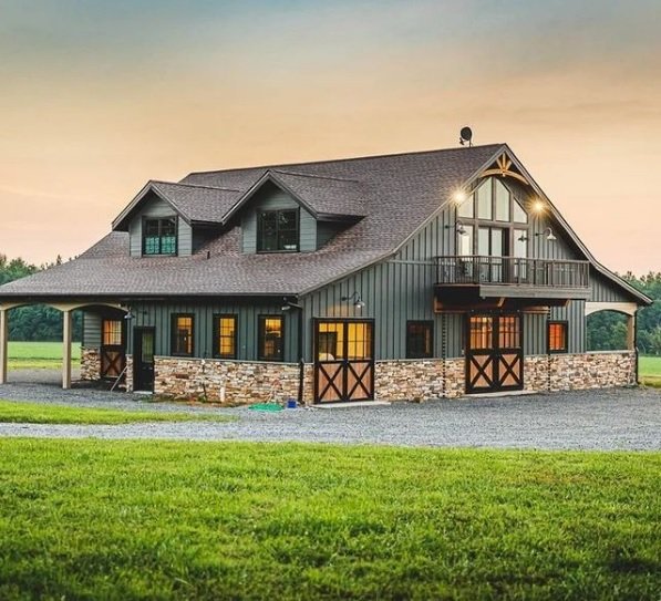 A large, gray barn with a stone foundation, multiple windows constructed in the Palouse