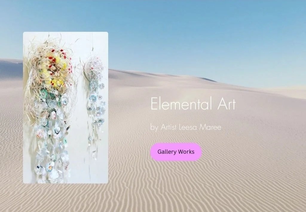 Artwork presented on sand dune backdrop.