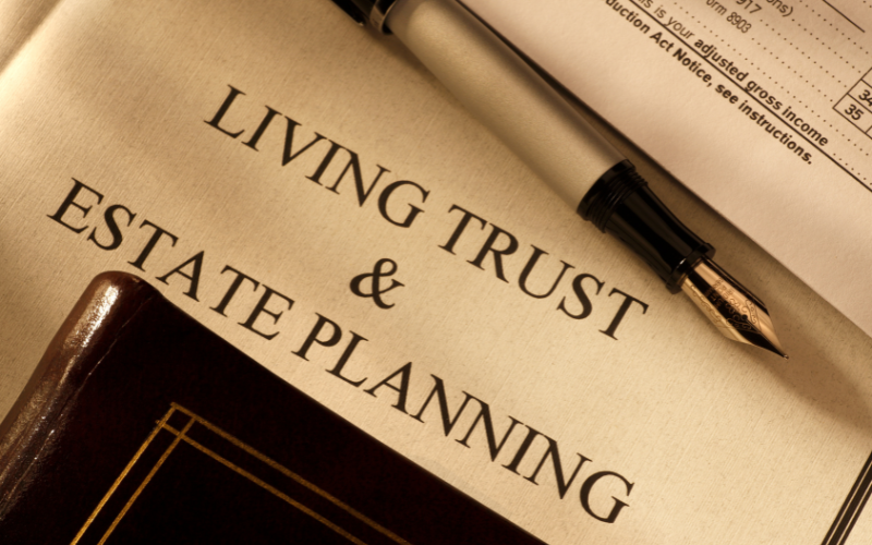 A magazine titled 'Living Trust & Estate Planning' with a pen resting on top of it.
