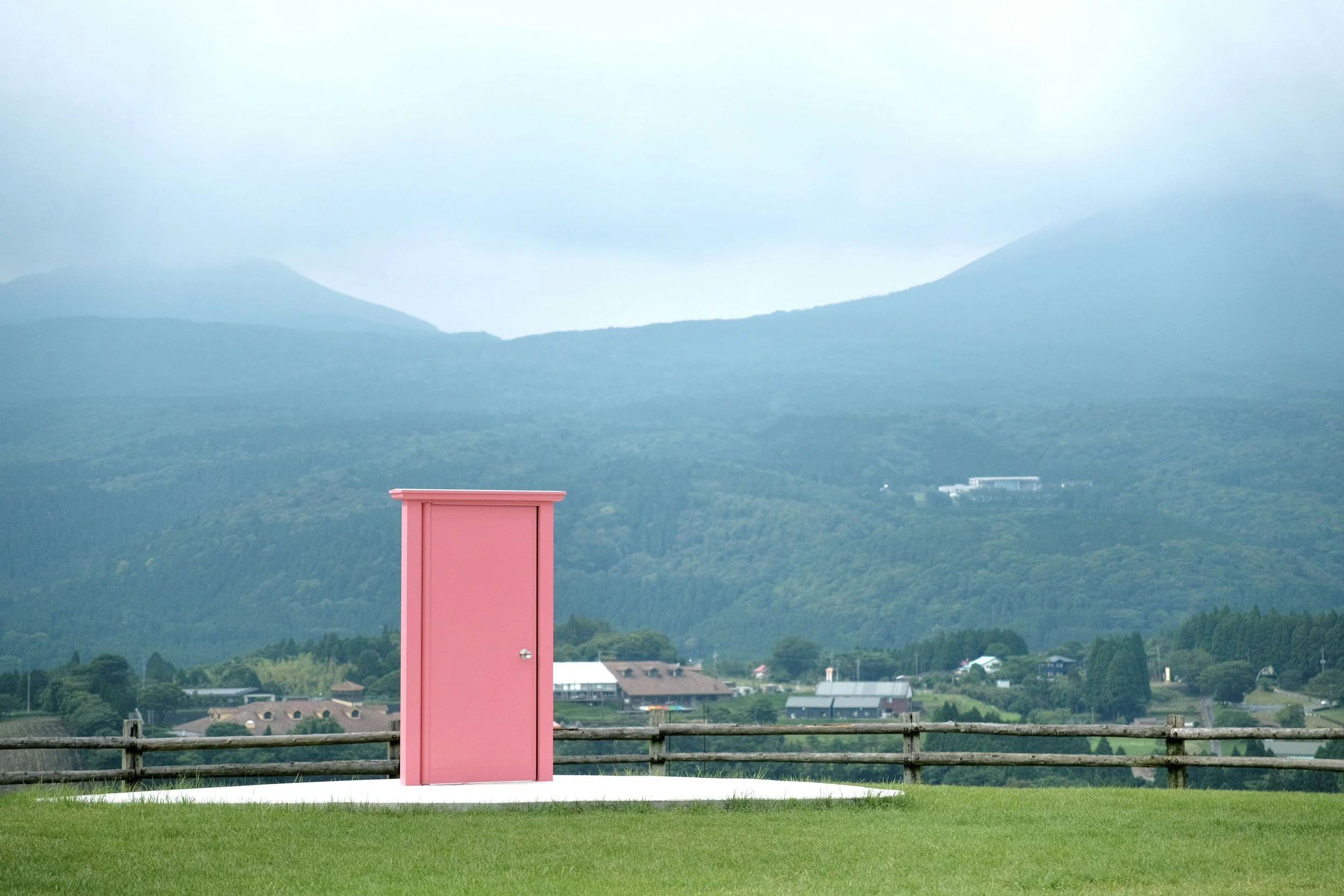 Pink door standing in random Okanagan BC field representing creative content ideas and a different perspective