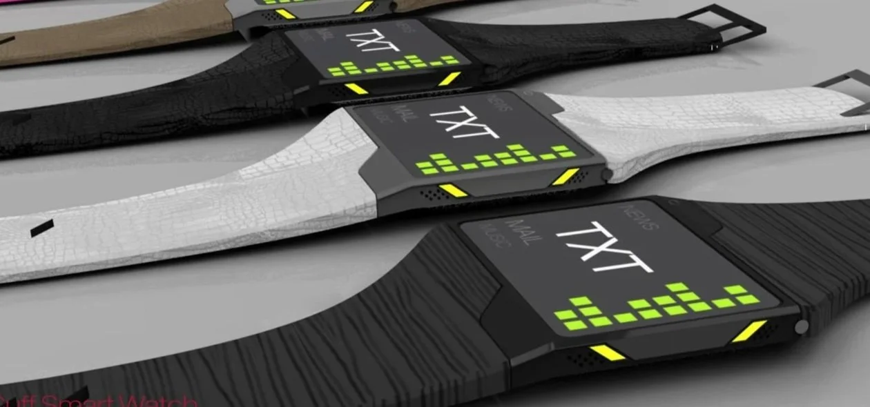 Multiple futuristic Rufus Cuff with digital displays and textured bands in black, white, pink, and brown colors, laid out on a flat surface.