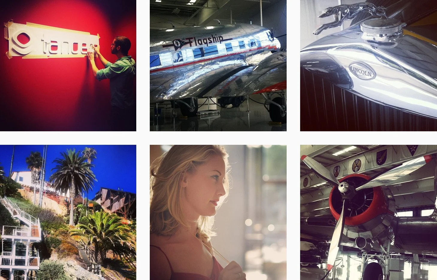 A collage of six images featuring various subjects: the first image shows a man installing a logo on a red wall, the second image displays a shiny vintage airplane labeled 'Flagship,' the third image is a close-up of a Lincoln car hood ornament, the fourth image captures a hillside with palm trees and a modern house, the fifth image shows a woman with blonde hair looking out a window, and the sixth image features an aircraft with military patches on it.