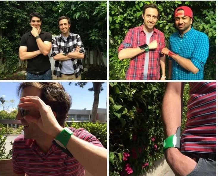 Collage of four photos featuring adults with brightly colored smartwatches. Top left shows two men standing outdoors, one with a thoughtful pose. Top right shows two men bumping fists, one wearing a backwards cap. Bottom left shows a woman outdoors, shielding her eyes from the sun. Bottom right shows a person with their hand in their pocket, wearing a striped shirt and smart watch.