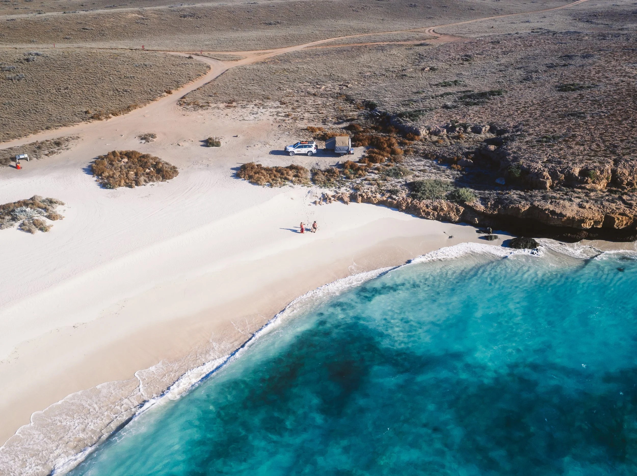 Aerial view of people relaxing near Ningaloo Reef in front of crystal clear waters