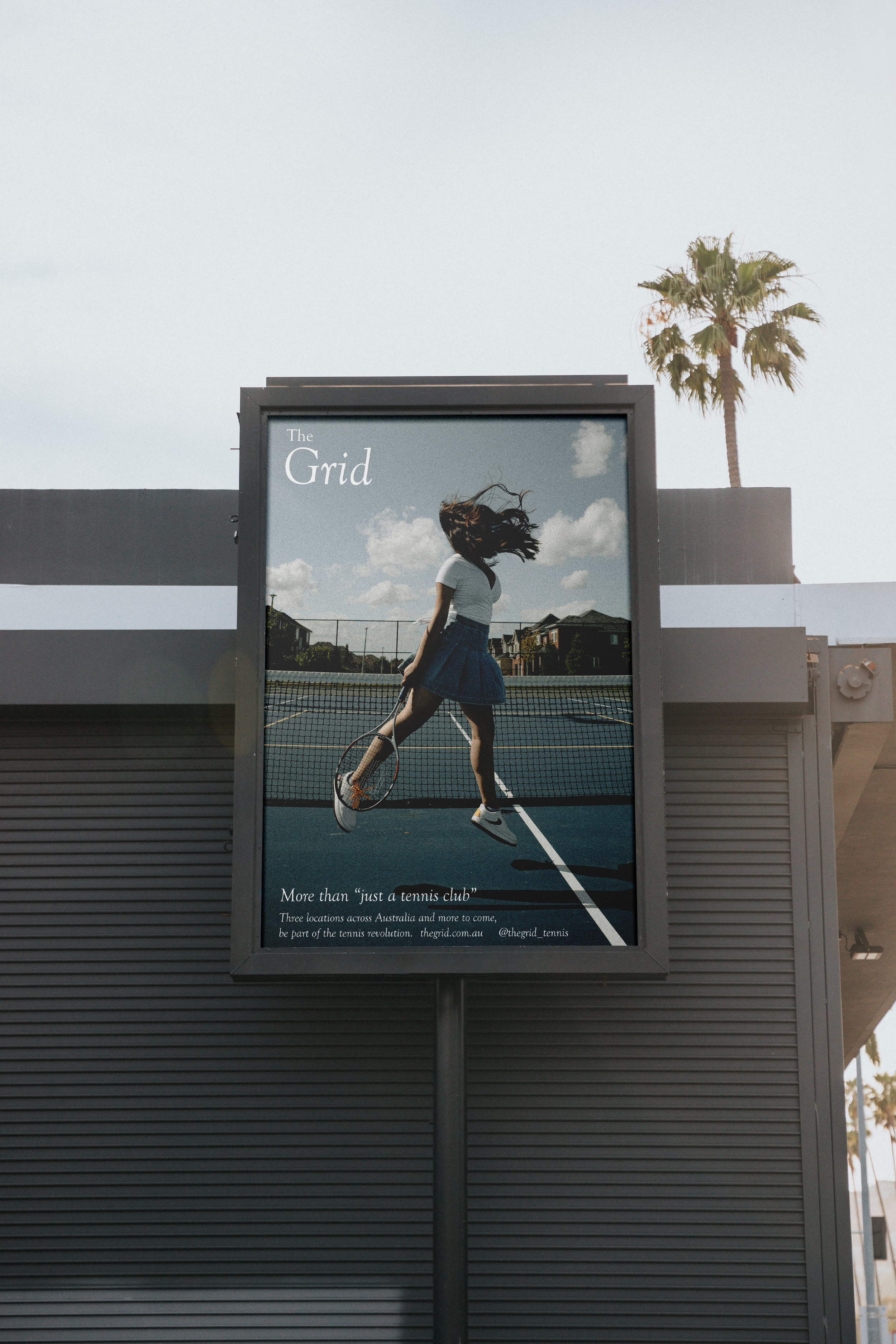 Image of a poster featuring a woman jumping on a blue clay tennis court featuring white text, infront of a grey building and palm tree.