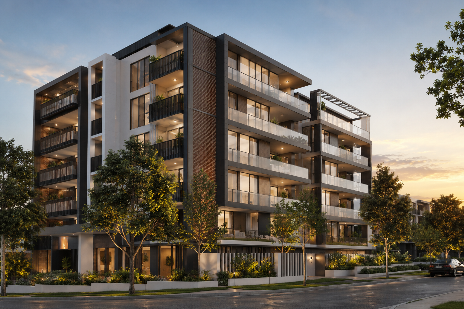 Modern multi-story residential building with large glass windows, balconies, and landscaped surroundings at sunset.