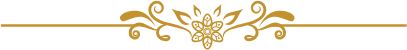 Decorative gold floral design with symmetrical swirls and a central flower motif