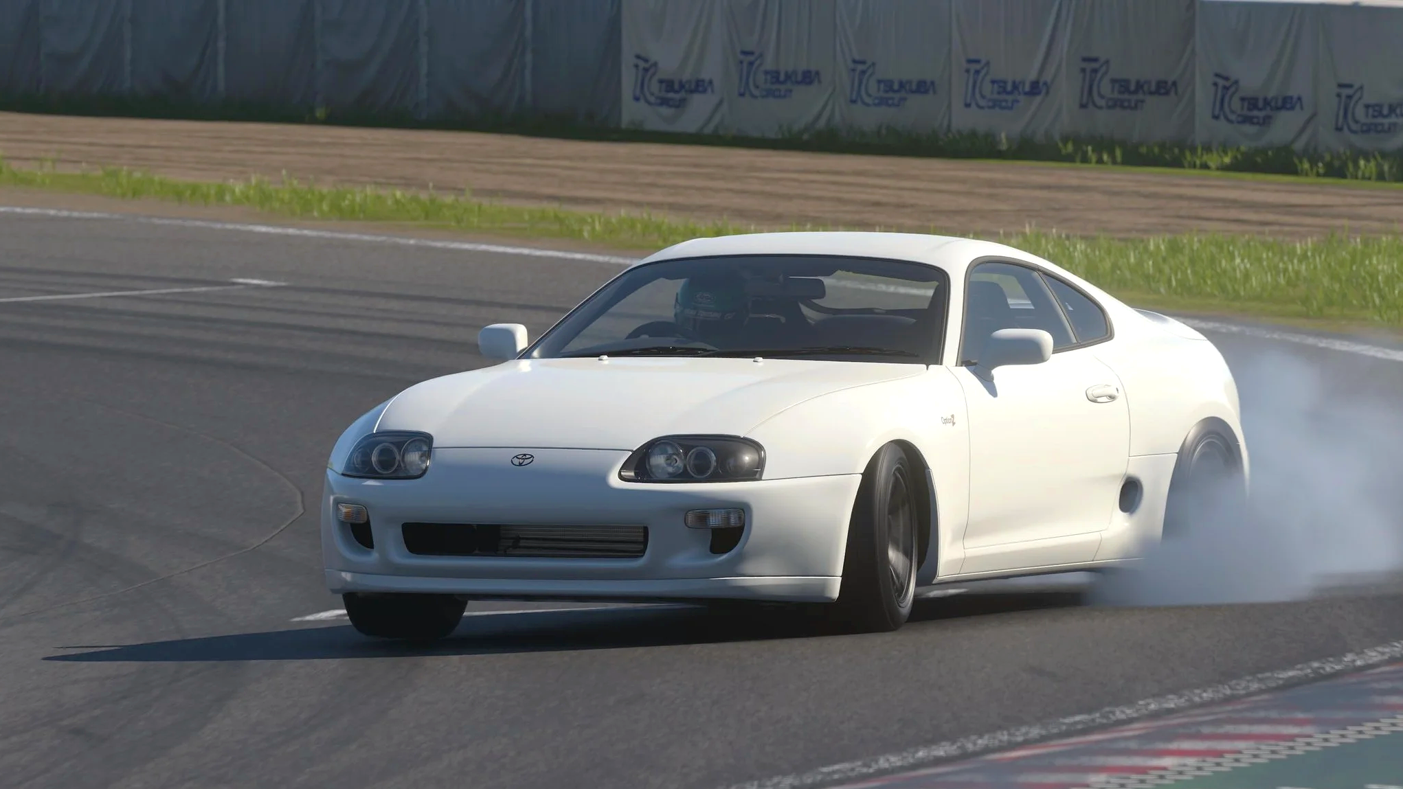 A white OptionZ Supra power slides around the final corner of Tsukuba circuit