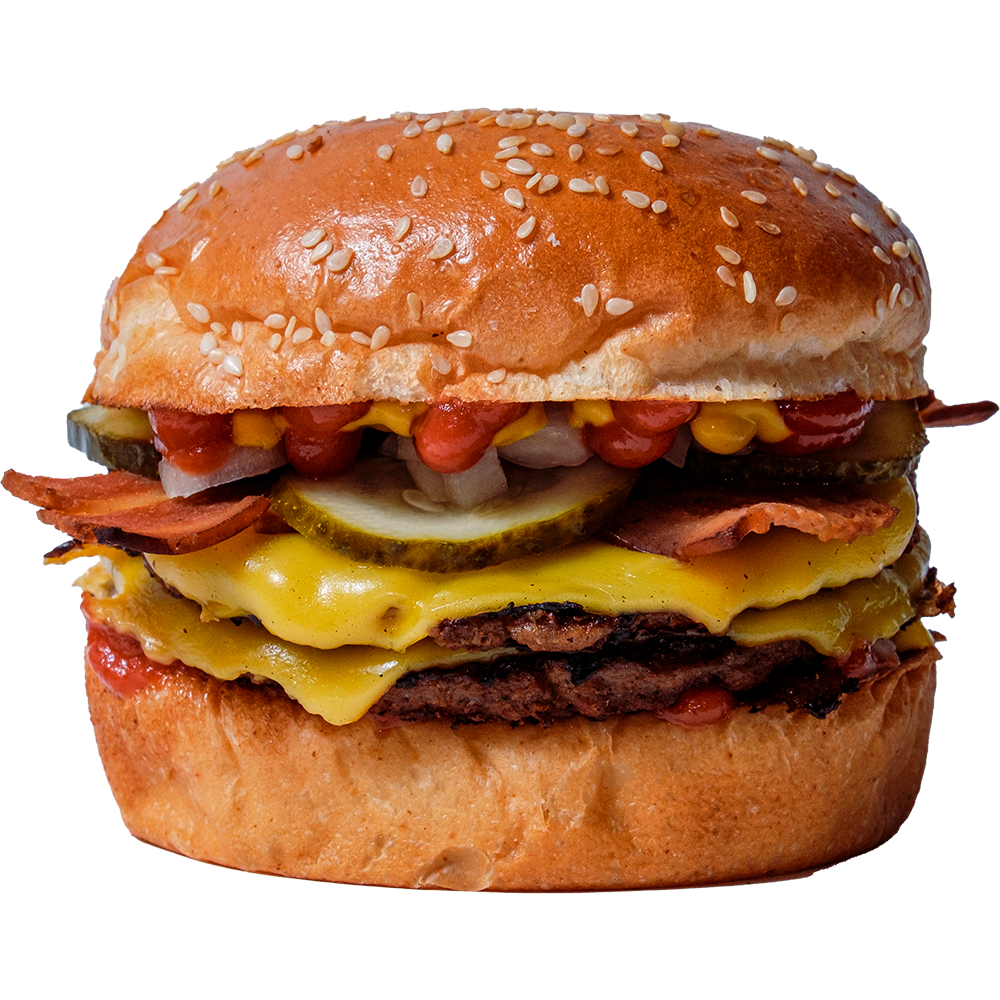 A close-up of diryt v's Astroworld-burger with a sesame seed bun, vegan, cheddar cheese, plant-beef patties, pickles, bacon, and condiments.