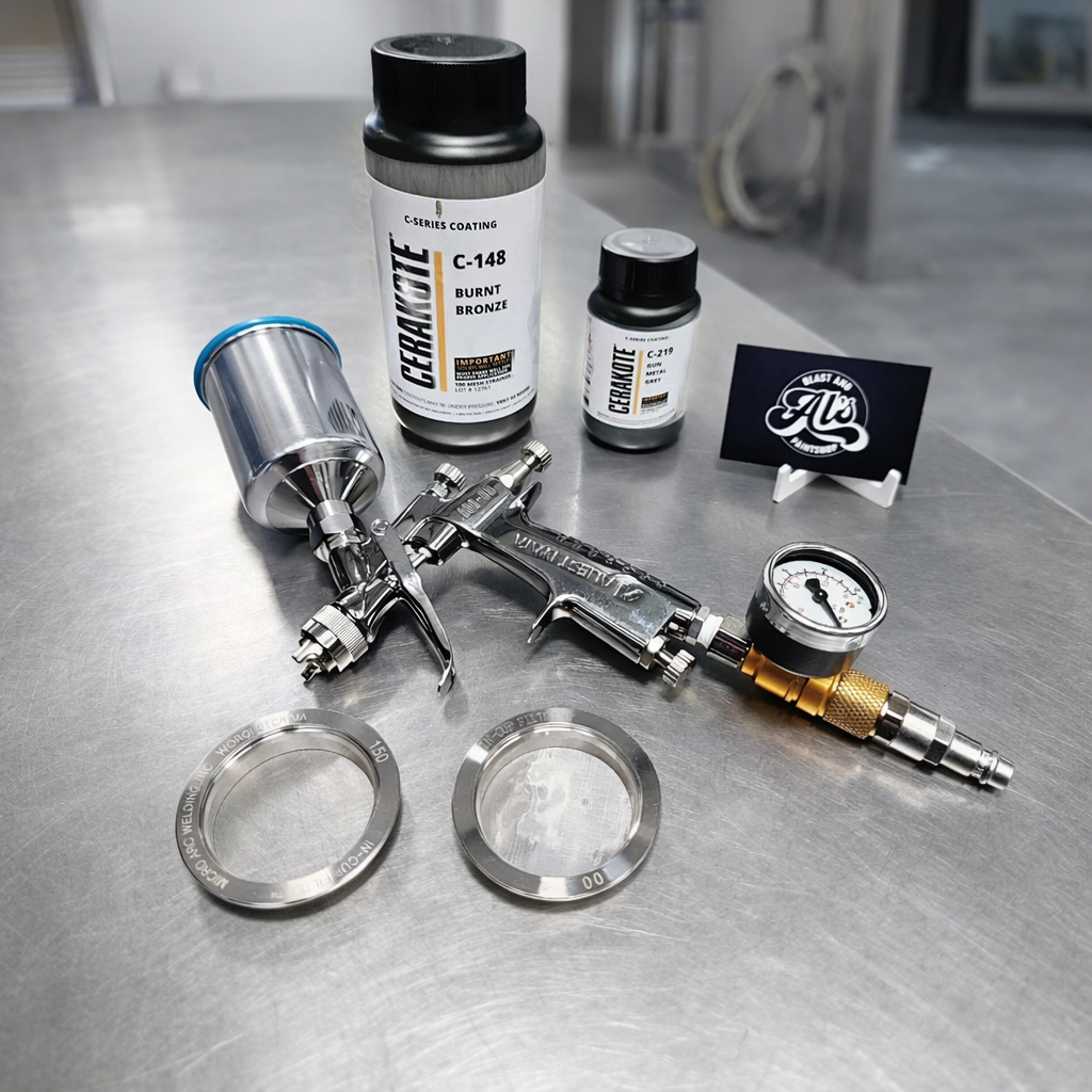 Airbrush tool, two bottles of ceramic coating, and various accessories on a metallic surface.
