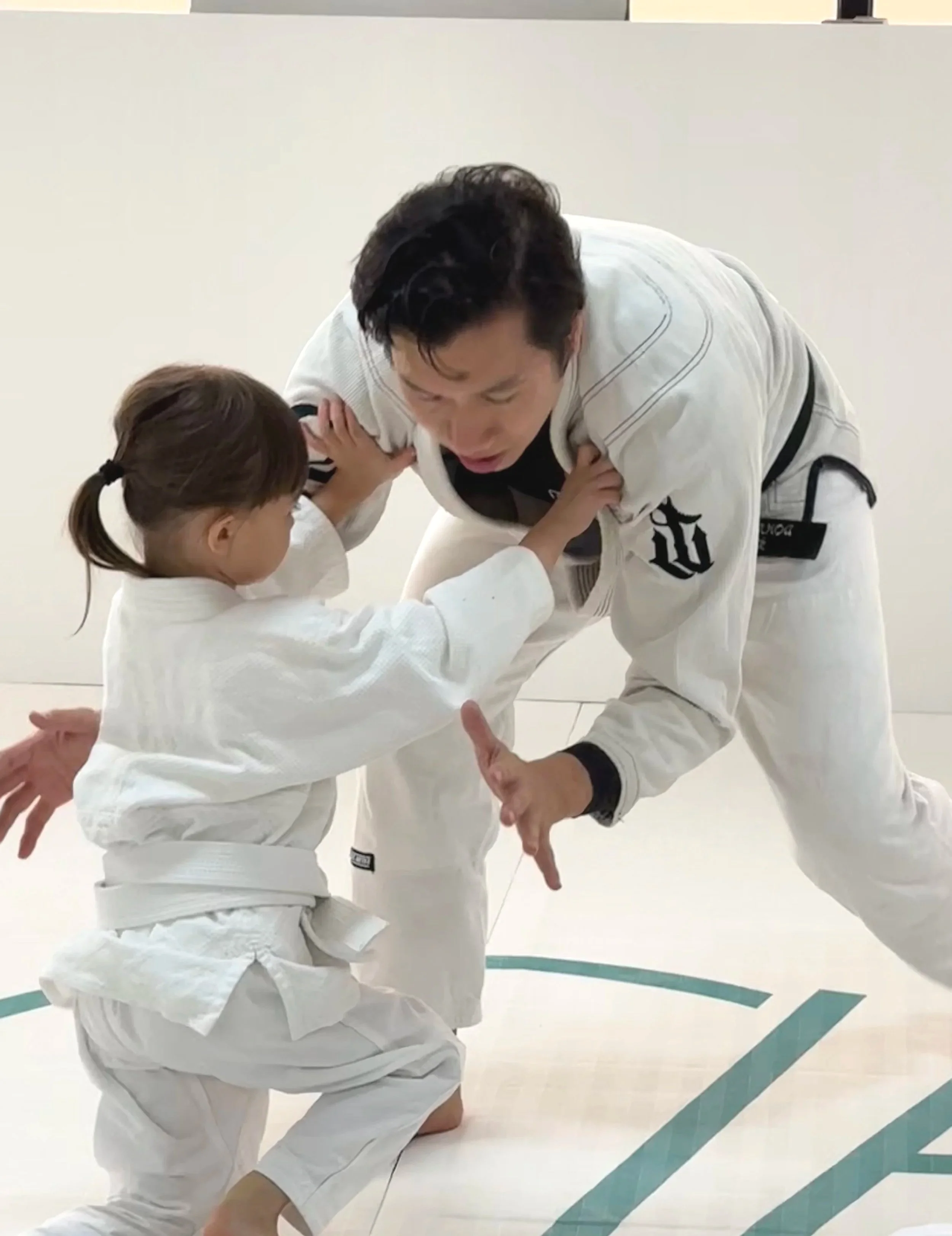 a 4 years old girl practicing Kid Brazilian Jiu-Jitsu.