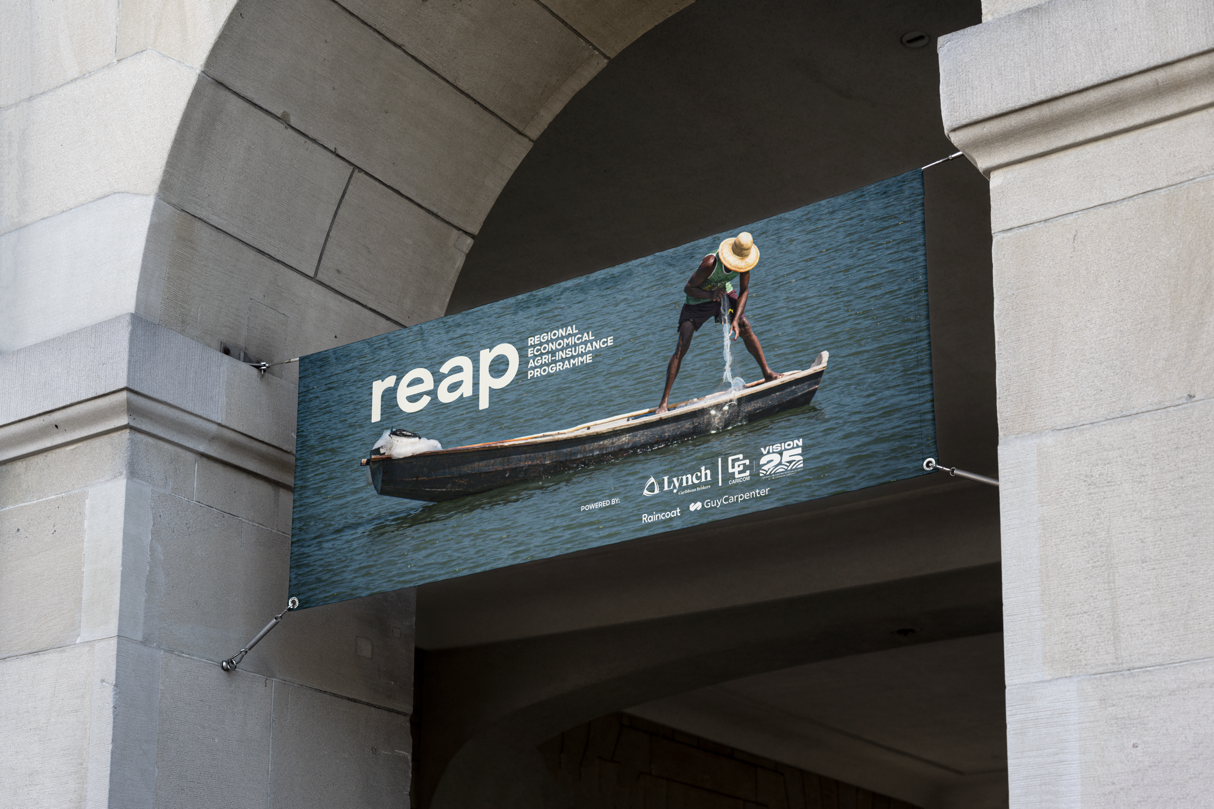 A billboard showing a person standing on a paddleboard in water, wearing a straw hat, with the text 'reap' and logos of various organizations.