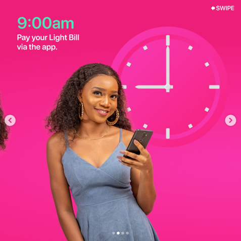Young woman in a blue dress smiling and holding a smartphone against a pink background with a clock and text encouraging paying utility bills via an app, with a swipe prompt in the top right corner.