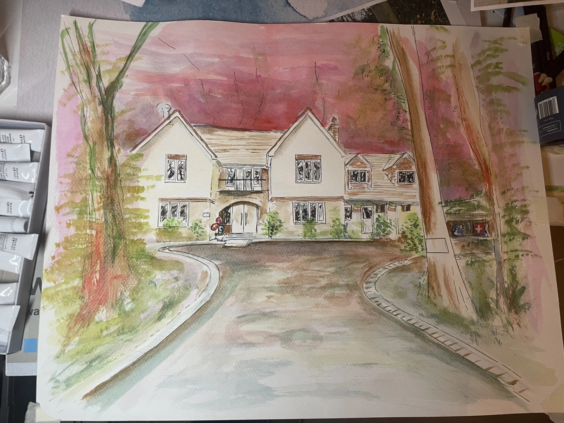 A watercolor painting of a large house with a driveway, front garden, and trees against a pink and purple sky.
