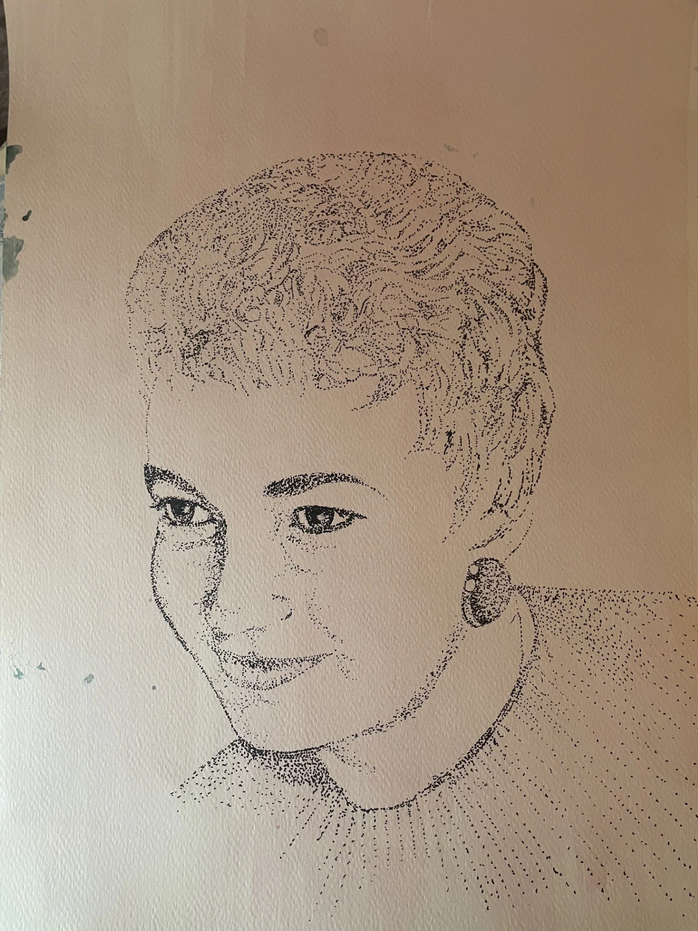 A black and white dot art portrait of a woman with short hair, earrings, and a gentle smile.