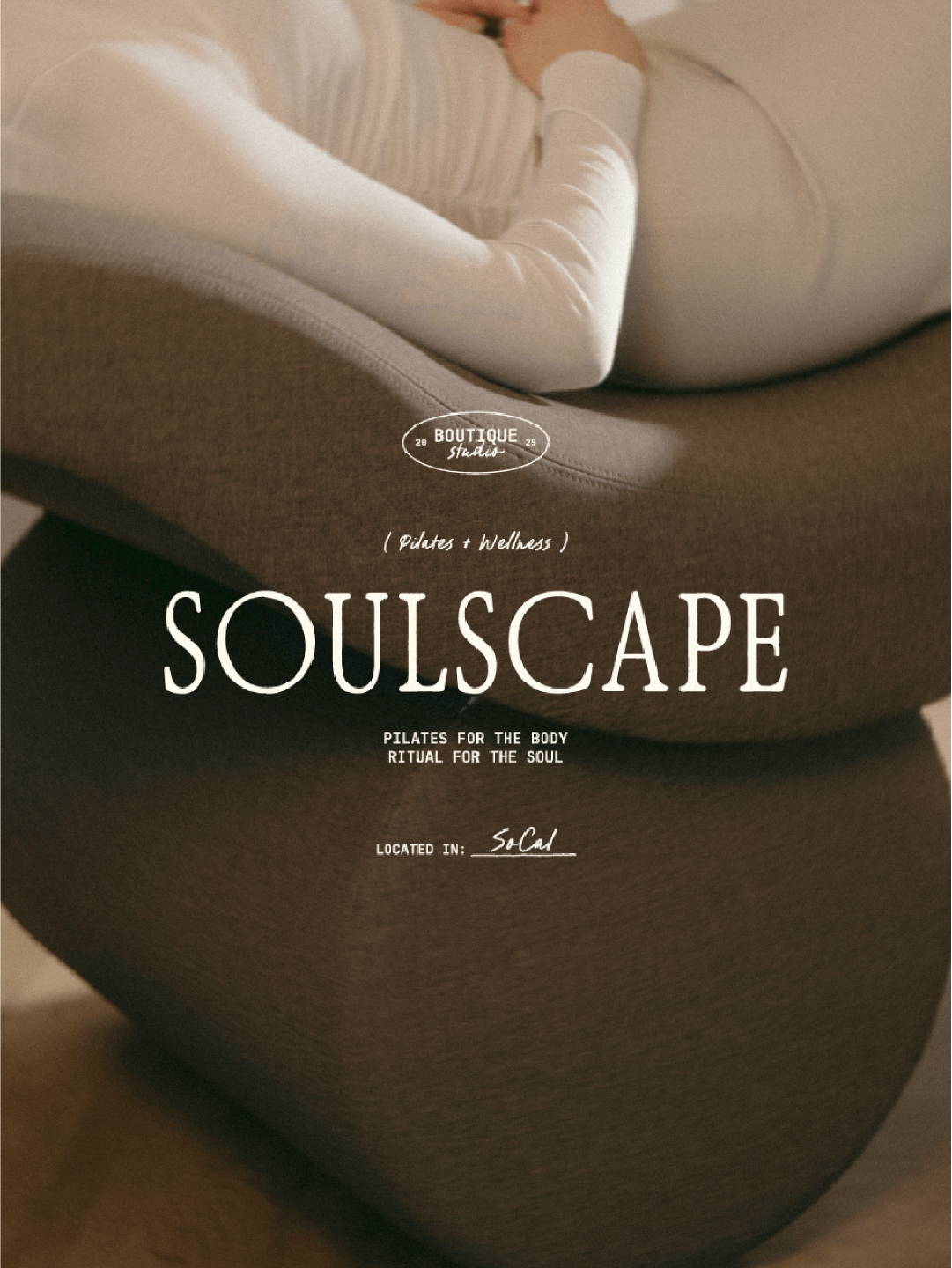 Text overlay advertising SOULSCAPE Pilates studio with a background of a person lying in a Pilates pose on a mat.