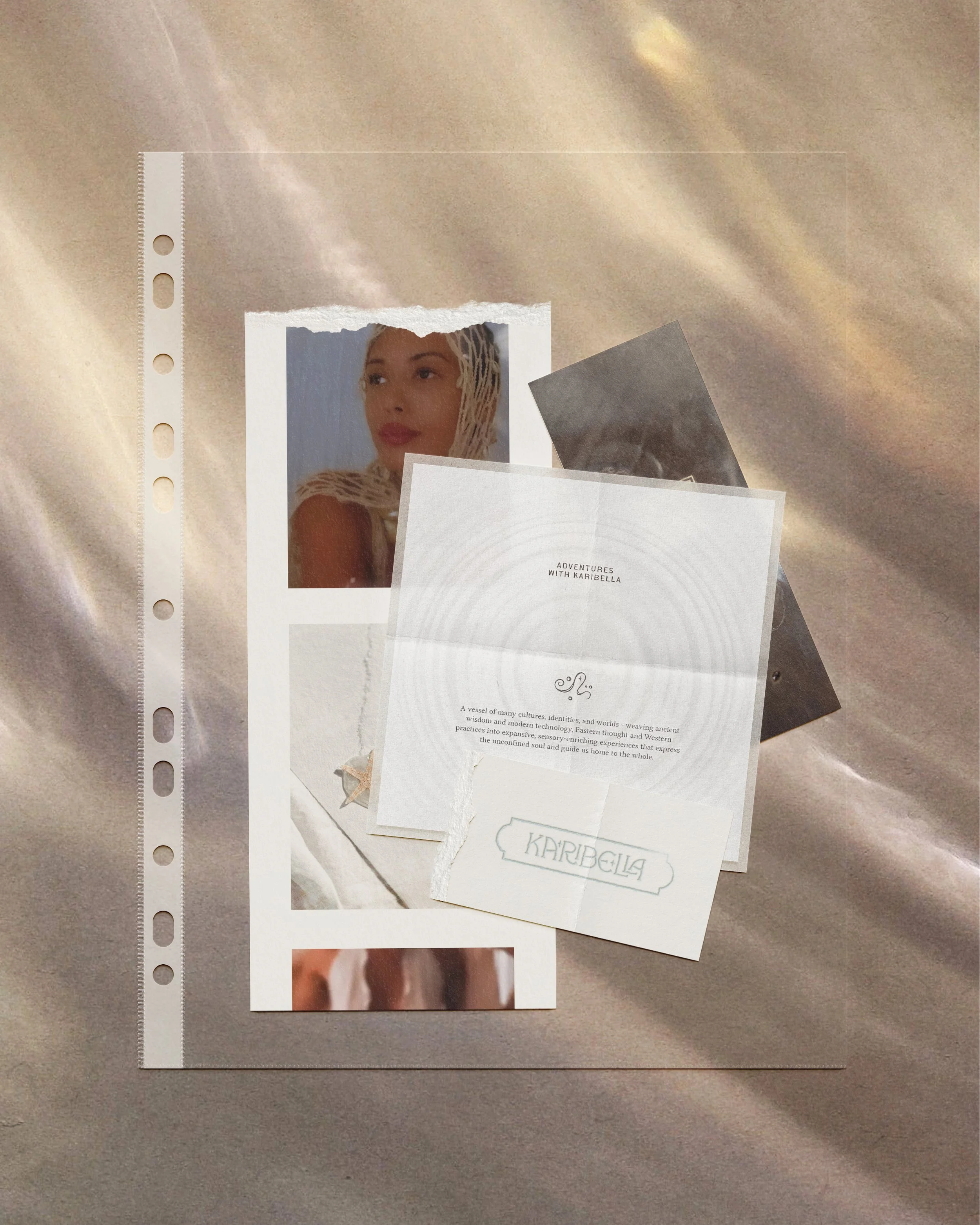 Collection of printed photos and paper items on a beige fabric surface, including a photo of a woman with a head covering, a card with 'Adventures with Karibella' and accompanying text, a torn paper with 'Karibella' written on it, and additional papers partially visible.