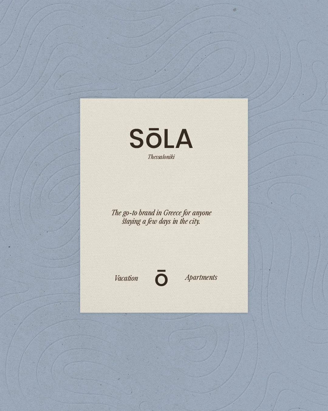 A promotional flyer for Sola Thessaloniki, a vacation and apartment brand in Greece. The background is light blue with subtle topographic lines. The central text is on a beige background with the brand name in bold, large font, followed by a tagline, and the words "Vacation" and "Apartments" with a circle in between.