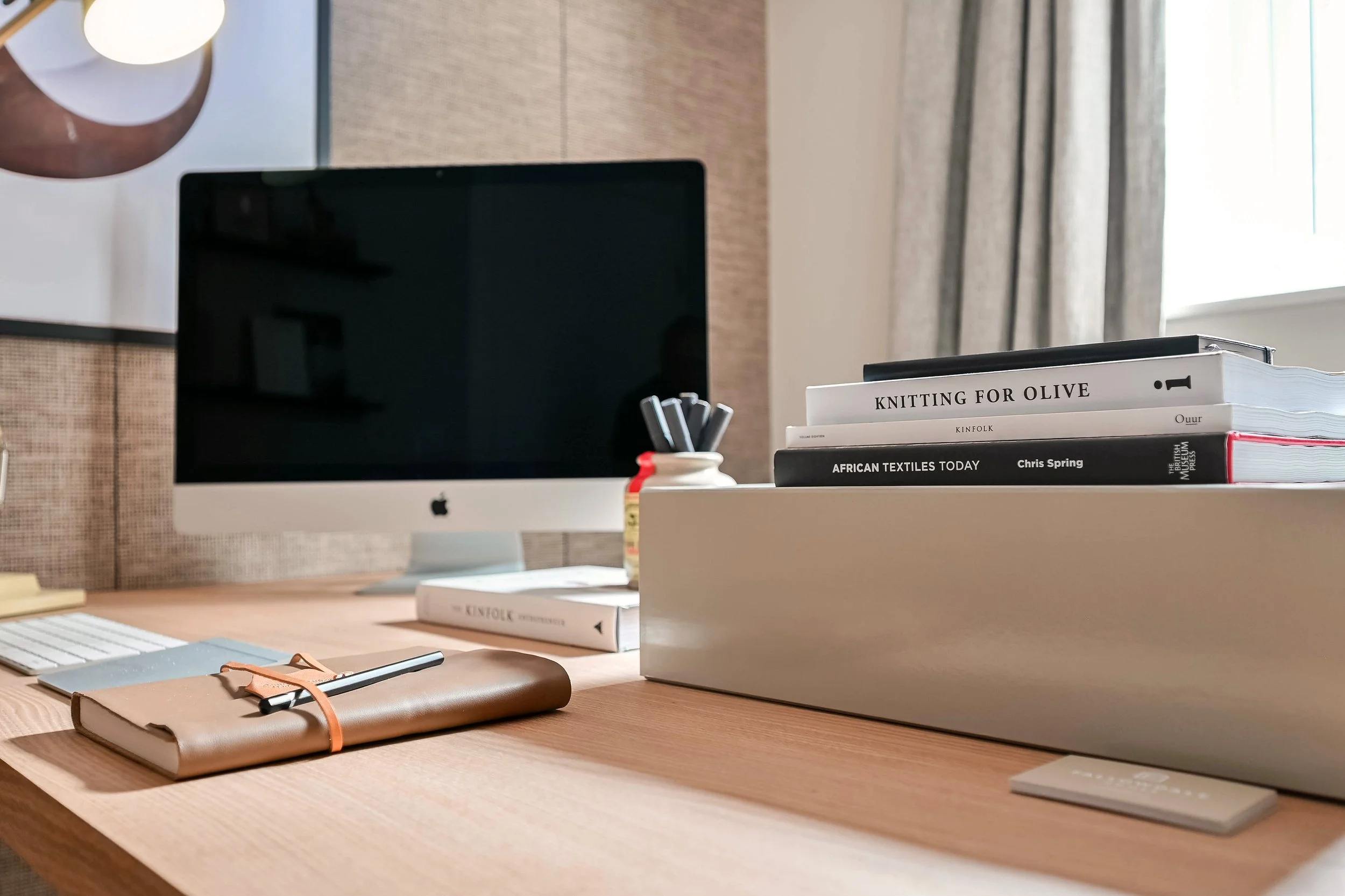 Close up of an Apple Mac computer in a show home office space