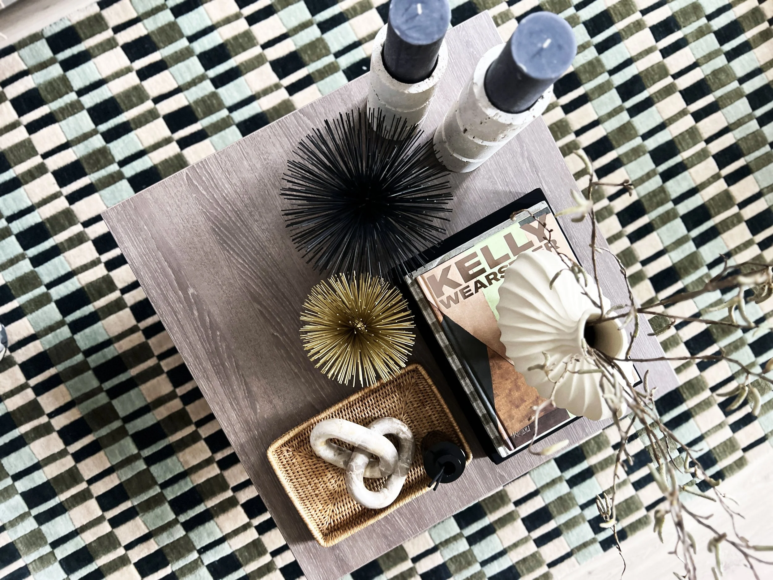 Unique show home styling - a bold patterned rug with an adorned side table