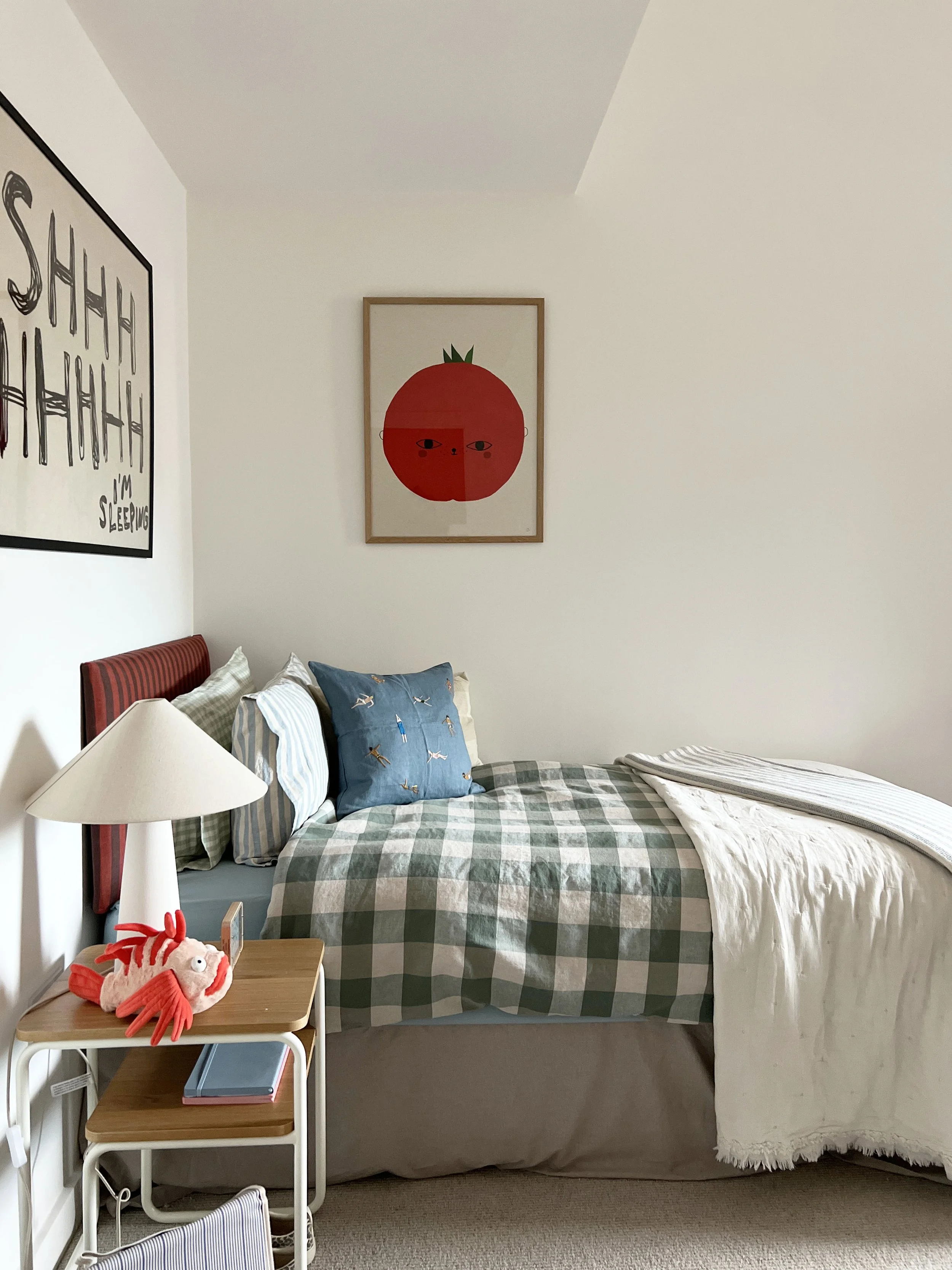 A gingham checked duvet adorning a neatly made bed in a neutral new build bedroom