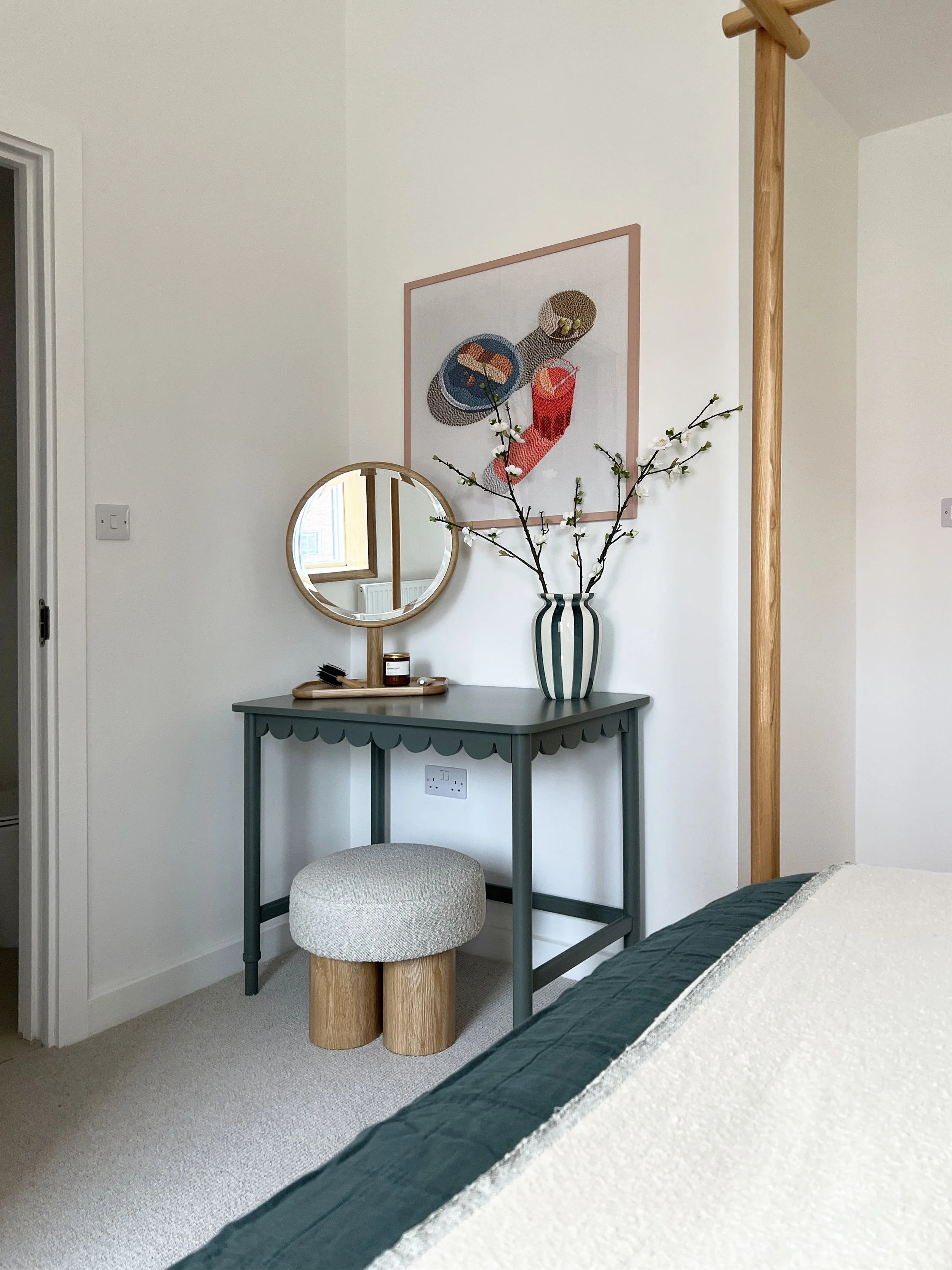 A large round dressing table mirror in a new build bedroom