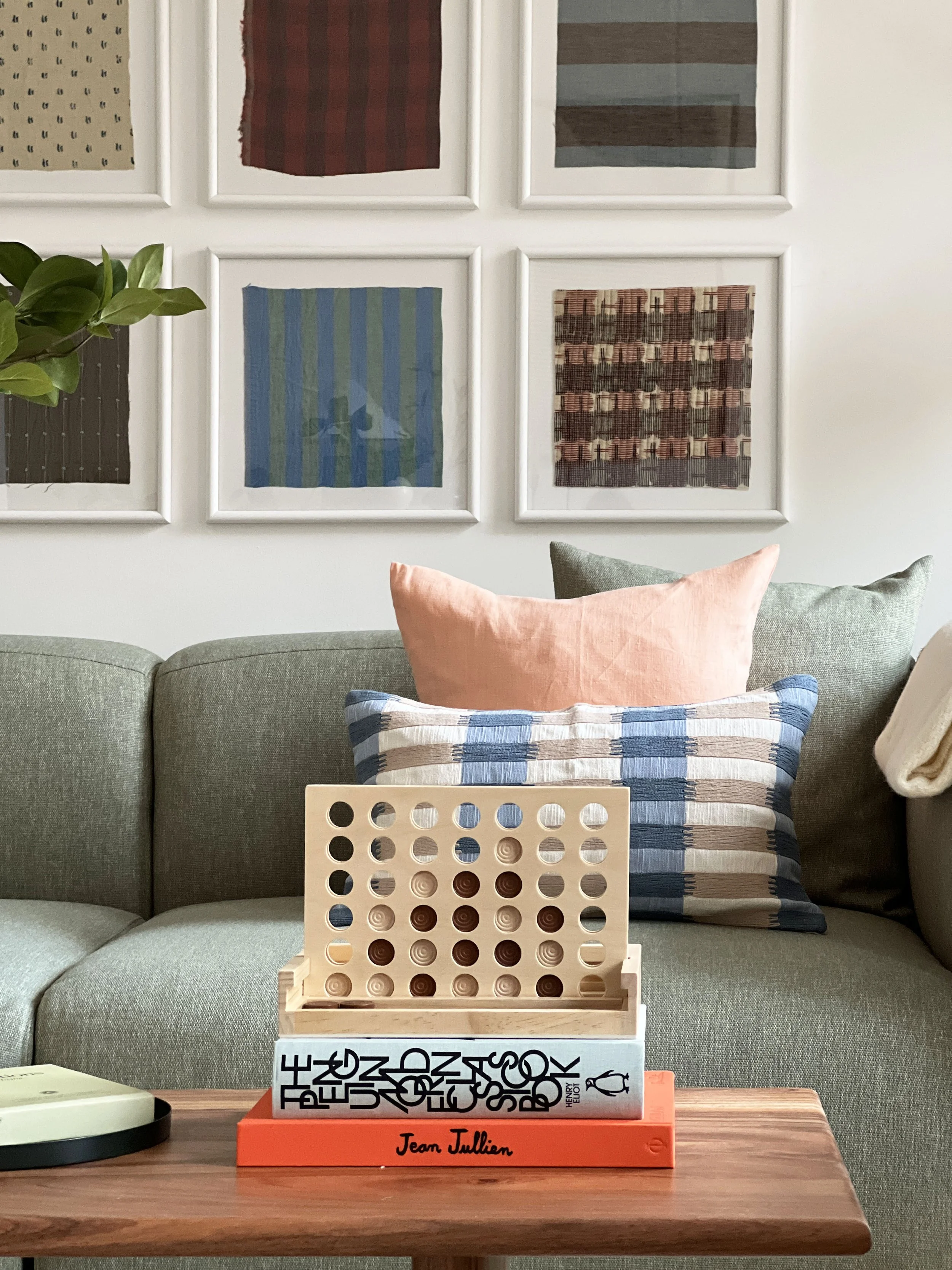 A living and playing space in a show home, with a game sat waiting to be played in front of a sofa