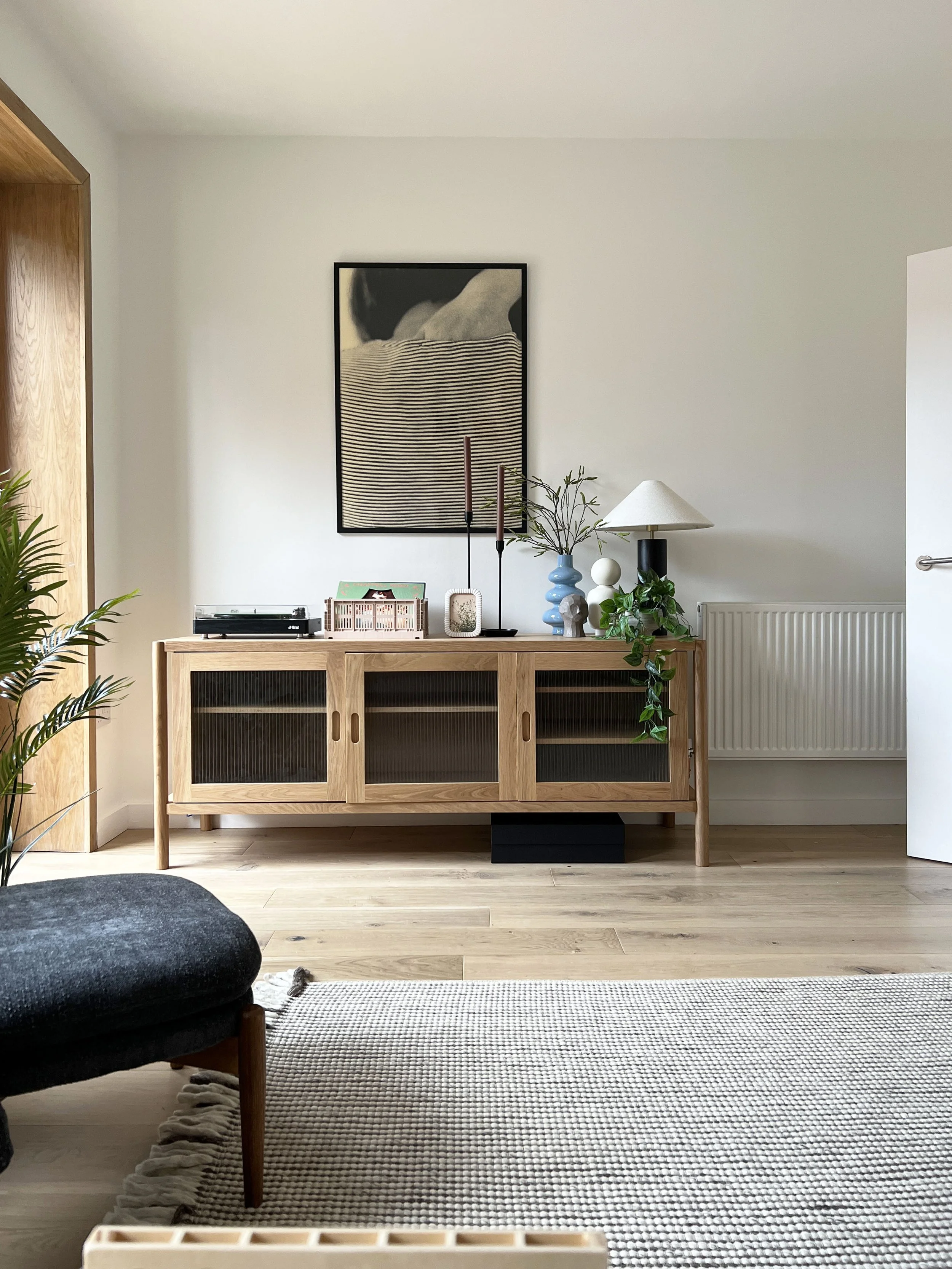 Open space in a show house with a simple storage sideboard styled by Fable for a show home
