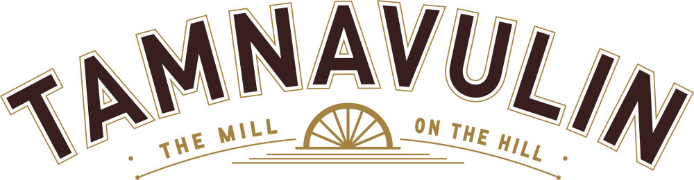 Logo for Tamnnavulin distillery featuring stylized text and a distillation wheel with the tagline "The Mill on the Hill".