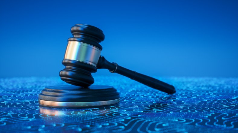 Gavel on a table with a blue background